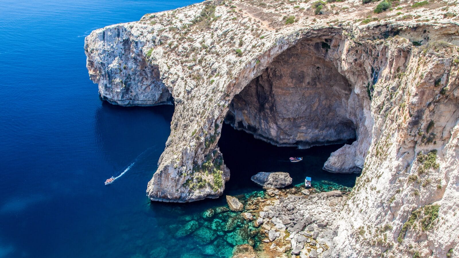 <p>The southern coast of Malta is home to a network of beautiful, dramatic caves cut into the cliffside by the surrounding sea over millions of years. As you approach the cave network by sea, you’ll be met by a giant 100-foot arch before witnessing stunning reflections of crystal clear water on the vaulted ceilings of the chambers.</p><p>The caves are famous for glowing in colors ranging from green to purple and orange, depending on their mineral composition.</p>