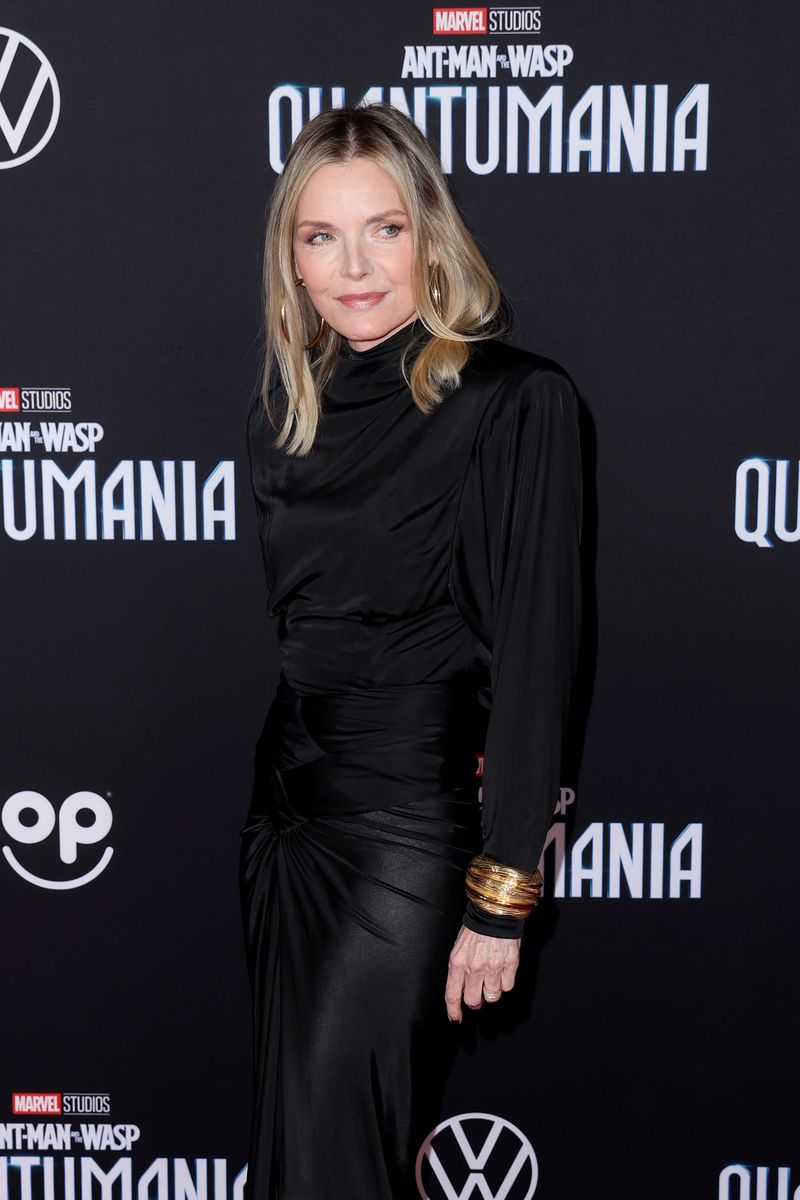 <p>Pfeiffer stunned in a clingy, high-neck dress with plenty of gold accessories at the <em>Ant-Man and the Wasp: Quantumania</em> premiere.</p>