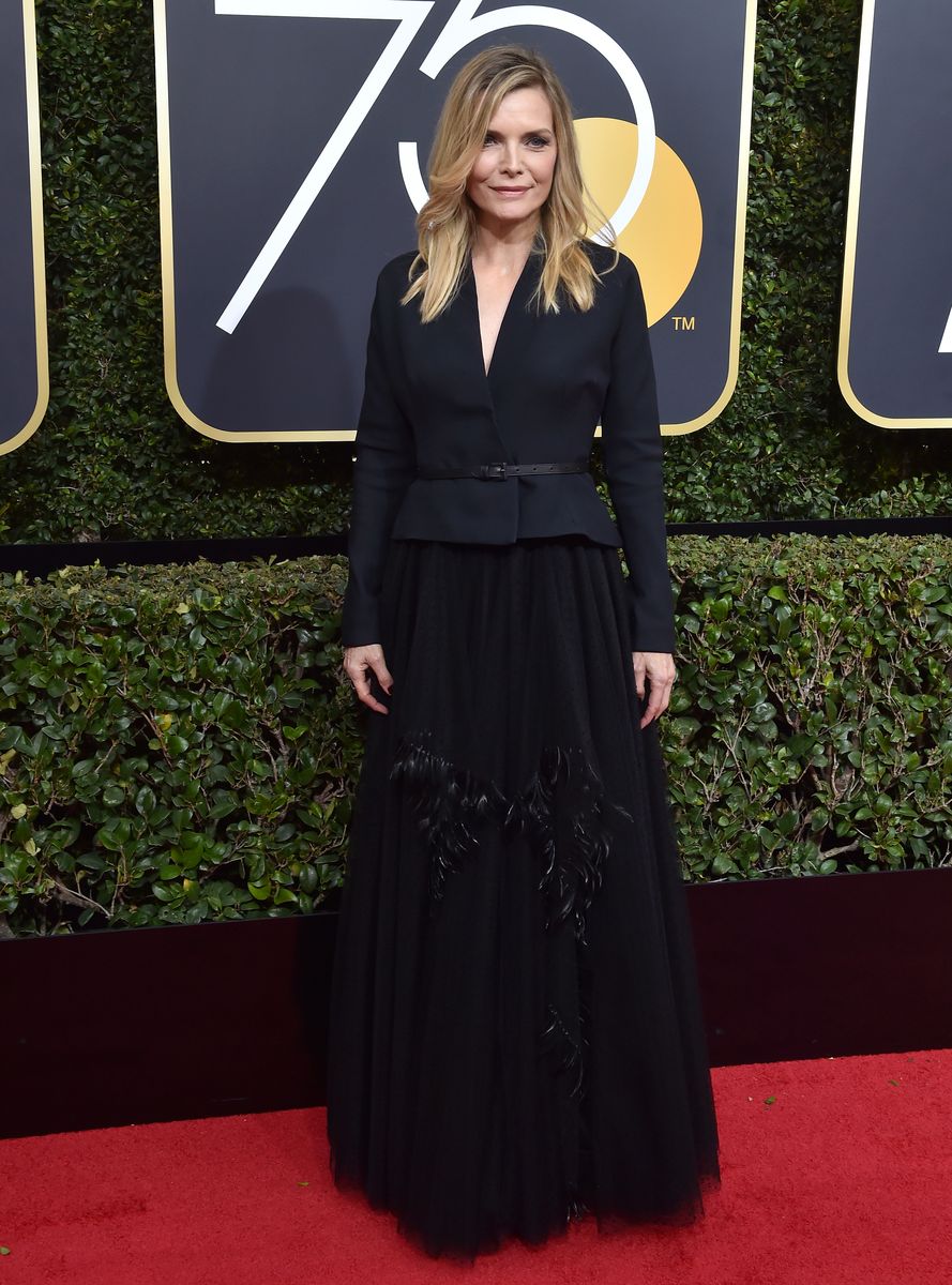 <p>Pfeiffer combined two unexpected pieces—a belted blazer and an embroidered floor-length tulle skirt—for the 2018 Golden Globe Awards.</p>