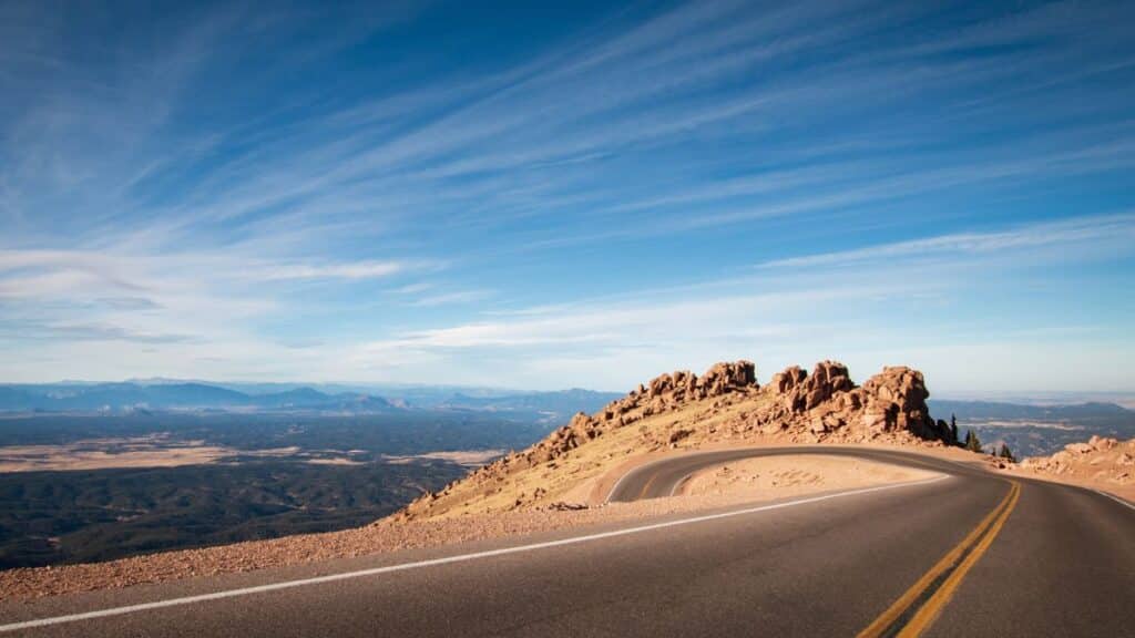<p>Pikes Peak Highway leads to the summit of Pikes Peak, one of America’s most famous mountains. This mountain is part of the Rocky Mountains, located in Colorado Springs. The journey up Pikes Peak Highway offers <a href="https://www.thewaywardhome.com/11-oceanfront-rv-parks-in-california-with-stunning-views-you-have-to-see-to-believe/" rel="noopener">stunning views</a> of green forests, alpine lakes, and the unique geological formations of the Garden of the Gods along the way.</p>