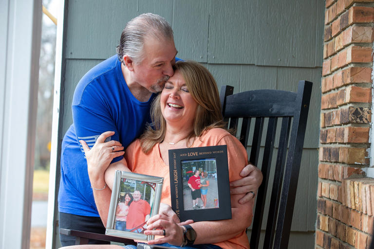 Brian and Donna Lapczynski of Forked River, who were childhood sweethearts in 1982, reconnected in 2010 and married in 2016, hold photographs from 2017 and 2010 as they talk about their memories together through the years at Six Flags Great Adventure at their home in Forked River, NJ Tuesday, March 5, 2024.
