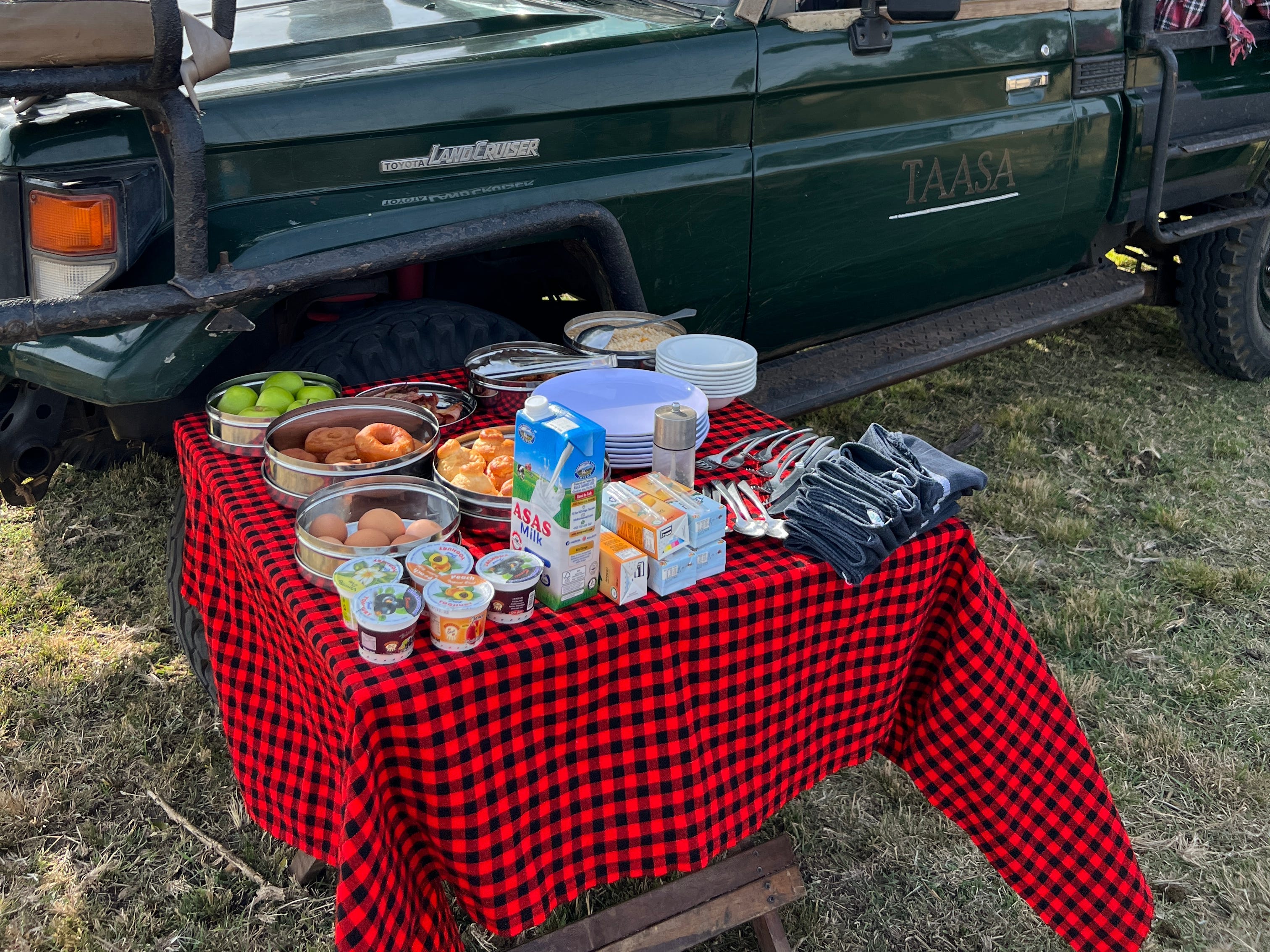 <p>Safari breakfasts consisted of hard-boiled eggs, yogurt, doughnuts, bacon and sausage, fruits, and orange juice. Staff also made French-press coffee, which we could spike with cream liqueur.</p><p>Our Land Cruiser had a cooler of beers and sodas in the back, too.</p>