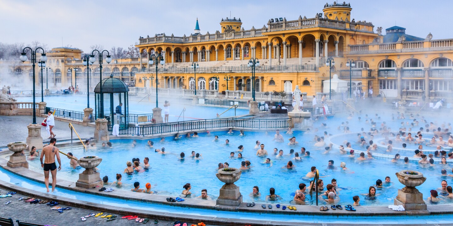 <p>You can enjoy the outdoor pools at Szechenyi even in the winter.</p><p>Shutterstock / Izabela23</p><p>For some, the mere mention of Budapest evokes images of steamy, tiled pools, tough-love masseuses, and lots of exposed skin. This is the City of Baths after all, and the 123 geothermal springs bubbling in caves under its hills and vales have soothed and healed locals, visitors, and even invaders since the Romans settled here nearly 2,000 years ago. </p><p>For those new to Budapest’s bathing culture, a few questions often come up: Do bathers have to be naked? Are men and women together or separated? What should I bring? How much does it cost? What about tipping? How does it all work? And, ultimately, is it worth it? Below, a rundown of their history, tips for visiting, and suggestions for our favorite baths in Budapest.</p>