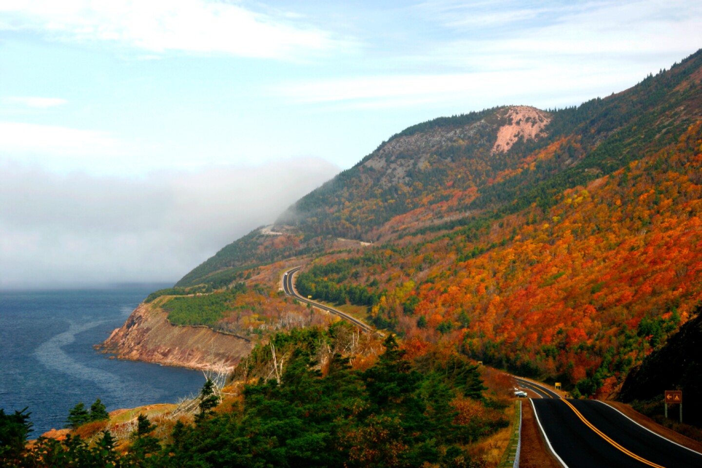 <h2>5. Cape Breton Highlands National Park</h2> <p><i>Nova Scotia</i></p> <p><a class="Link" href="https://www.pc.gc.ca/en/pn-np/ns/cbreton/" rel="noopener">Cape Breton Highlands National Park</a> in northern Nova Scotia offers plenty to do across its mix of highland and ocean landscapes. You can enjoy much of the scenery in this 360-square-mile park without leaving the car, with the Route 30 loop (also known as the Cabot Trail) bracing the shores of the Atlantic on one side and the Gulf of St. Lawrence on the other. Drive slowly, and not just for the coastal views that greet you at every mile—this is whale country, and particularly lucky visitors may get a glimpse of a minke or pilot whale coming up for air. You can also cycle part of the 185-mile loop course or opt to hike some of the park’s 26 scenic trails.</p> <h3>How to get to Cape Breton Highlands National Park</h3> <p>This part of Nova Scotia is most easily accessed through Halifax airport, which connects directly to many hubs on the continent. From there, you’ll drive around 150 miles north to get to Cape Breton Island. Travel north another 65 miles on Nova Scotia Highway 105 and you’ll reach Cabot Trail. This last 50-mile leg to the park is about an hour-long drive.</p>