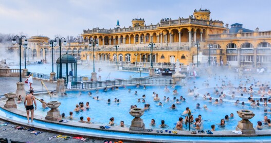 <p>For some, the mere mention of Budapest evokes images of steamy, tiled pools, tough-love masseuses, and lots of exposed skin. This is the City of Baths after all, and the 123 geothermal springs bubbling in caves under its hills and vales have soothed and healed locals, visitors, and even invaders since the Romans settled here nearly 2,000 years ago. </p> <p>For those new to Budapest’s bathing culture, a few questions often come up: Do bathers have to be naked? Are men and women together or separated? What should I bring? How much does it cost? What about tipping? How does it all work? And, ultimately, is it worth it? Below, a rundown of their history, tips for visiting, and suggestions for our favorite baths in Budapest.</p> <h2>The history of Budapest’s baths</h2> <p>The original Roman baths remain only as archaeological sites, but they kicked off centuries of soaking. Hammam-style baths with octagonal main pools, like <a class="Link" href="https://www.afar.com/places/rudas-thermal-baths-budapest" rel="noopener">Rudas</a>, date to the 150-year Ottoman occupation era (1541–1699). The century-old tiles and vaulted ceiling of the <a class="Link" href="https://www.afar.com/places/gellert-baths-budapest" rel="noopener">Gellért baths</a> and the distinctive wedding-cake yellow palaces of the <a class="Link" href="https://www.afar.com/places/szechenyi-thermal-bath-budapest-c2624faa-db48-441f-8939-87ba38db5e00" rel="noopener">Széchenyi baths</a> date to the late Austro-Hungarian empire and are grandly Beaux-Arts and neo-baroque. A smattering of Budapest’s bathhouses are much newer: The <a class="Link" href="https://www.danubiushotels.com/en/our-hotels-budapest/danubius-hotel-helia" rel="noopener">Danubius Hotel Helia</a> and <a class="Link" href="https://aquincumhotel.com/" rel="noopener">Aquincum</a>, both contemporary hotel baths, have brought Budapest bathing up to date.</p>