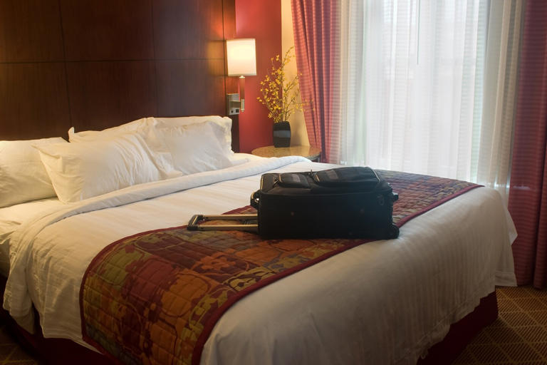 If you've ever wondered why that little bed scarf some hotels use at the foot of the bed exists-just think of how many people unpack their bags on the beds.