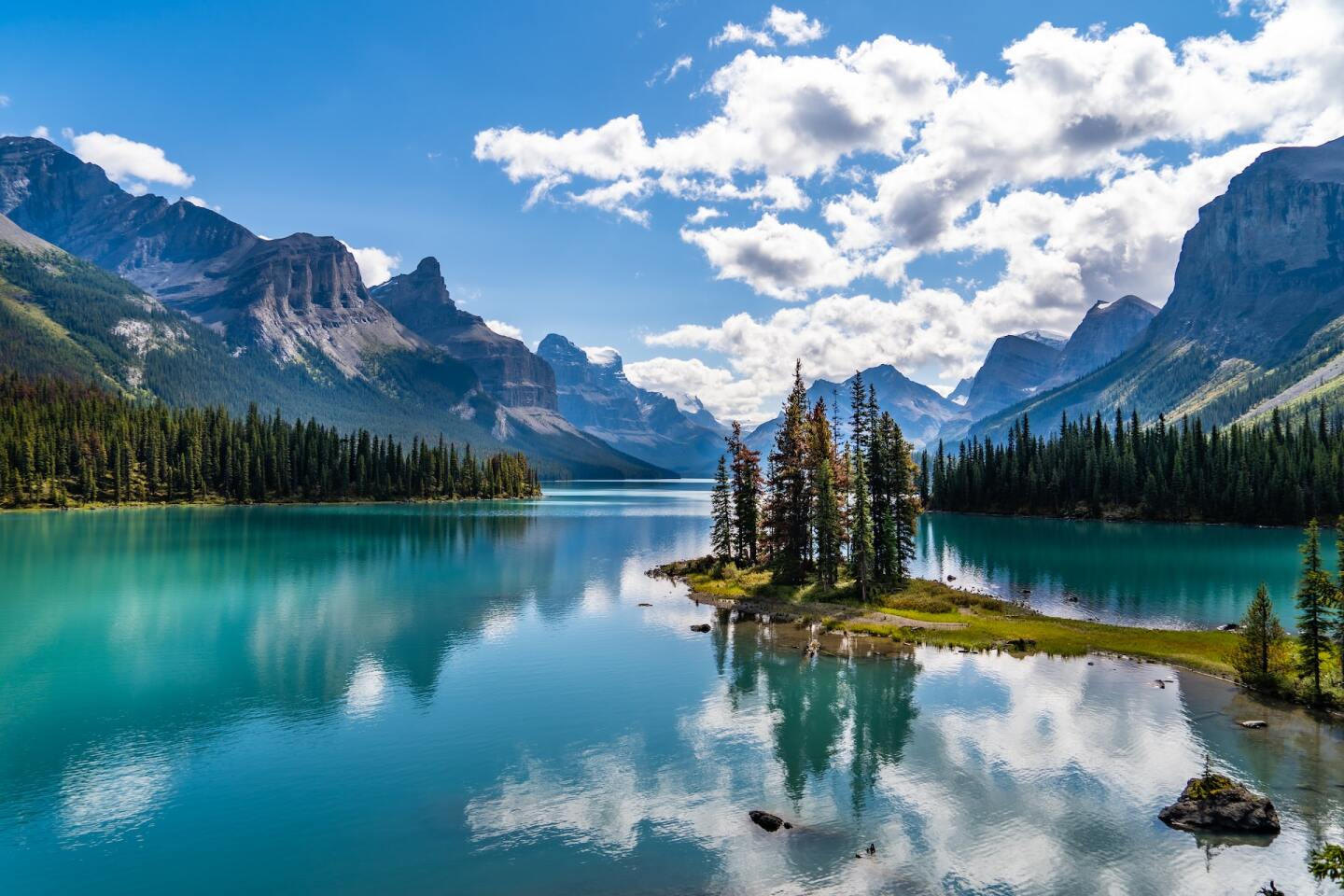 <h2>4. Jasper National Park</h2> <p><i>Alberta</i></p> <p>If you think Banff is all there is to the Canadian Rockies, think again: When <a class="Link" href="https://whc.unesco.org/en/list/304/" rel="noopener">UNESCO</a> declared the area a World Heritage site in 1984, it also included the parks of Jasper, <a class="Link" href="https://www.pc.gc.ca/en/pn-np/bc/kootenay" rel="noopener">Kootenay</a>, and <a class="Link" href="https://www.pc.gc.ca/en/pn-np/bc/yoho" rel="noopener">Yoho</a>. The biggest of the four—<a class="Link" href="https://www.afar.com/magazine/the-essential-guide-to-jasper-national-park-canada" rel="noopener">Jasper National Park</a>—spans a whopping 4,300 square miles. With a 2021 yearly visitor count of <a class="Link" href="https://parks.canada.ca/pn-np/ab/jasper/gestion-management/plan/2021" rel="noopener">2.1 million people</a> (compared to Banff’s 3.6 million), Jasper’s relative <a class="Link" href="https://www.afar.com/magazine/how-to-beat-the-crowds-at-banff-national-park" rel="noopener">lack of people </a>lends itself to more Kodak moments with Rocky Mountain wildlife.</p> <p>If you <i>do </i>want to travel to one of the park’s more popular attractions, head to Maligne Lake, the largest natural lake in the Canadian Rockies. Check out the vistas, which include the three glaciers you can see throughout the year.</p> <h3>How to get to Jasper National Park</h3> <p>Edmonton’s airport is close to Jasper and gets direct flights from plenty of North American airports, including Denver and San Francisco. Once you fly in, be prepared to buckle up and drive, because the park is still 200 miles away. But if you’re going to Banff National Park in the same trip, driving Highway 93—also known as the Icefields Parkway—between them offers an exceptionally picturesque route, with views of ancient glaciers, lakes, and Rocky Mountain larches and pines.</p>