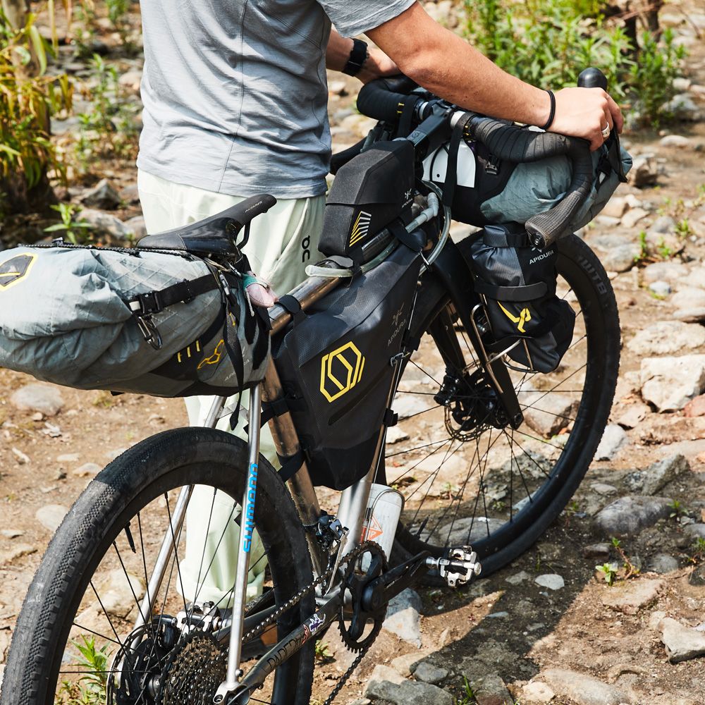 <p>Bikepacking is my absolute favorite way to travel. I love living in a big city, but my soul yearns to occasionally get away and pedal across countries to camp out in parts of the world most people would call “unreachable.” Pre-planned bikepacking routes, like the ones found at <a href="http://bikepacking.com"><em>bikepacking.com</em></a>, will take you on long, winding journeys to remote places all over the world.</p><p>To me, bikes symbolize freedom, and bikepacking is the pinnacle of that freedom. There’s always another mountain looming in the distance or a remote village to visit, and the majority of the days end at a campsite with a stunning view. (There may be mosquitos and sand flies, too, but the view’s worth it.)</p><p>Bikepacking routes feature long rides over bumpy, unpaved surfaces like dirt, rock and gravel. We’re talking about riding for hours day after day on towpaths, rail trails, forested singletracks and all-but-forgotten dusty roads that lead to some of the most beautiful and diverse places in the world. For these kinds of adventures, you need a bike that is durable, reliable, and relatively easy to repair trail-side. It also helps to have lots of mounts or <a href="https://framebuildersupply.com/collections/bosses">‘bosses’</a> to attach cages and/or frames to help you load up your camping gear. The best bikes for bikepacking can carry the load, opening the door for you to go on some incredible cycling adventures.</p><p class="body-tip"><strong>Go on a Cycling Adventure!</strong> <a href="https://www.bicycling.com/bikes-gear/g40299771/best-water-bottle-cages-cycling/">Best Water Bottle Cages</a> <strong>●</strong> <a href="https://www.bicycling.com/bikes-gear/mountain-bike/a23342484/best-mountain-bike-shorts/">Best Mountain Biking Shorts</a> <strong>●</strong> <a href="https://www.bicycling.com/culture/a26559273/best-cycling-tours/">The Best U.S. Cycling Tours</a></p><h2 class="body-h2">The Best Bikes for Bikepacking</h2><ul><li><strong>Best Overall: </strong><a href="https://www.curvecycling.com/products/gmx-titanium">Curve GMX+ Titanium</a></li><li><strong>Best Value: </strong><a href="https://go.redirectingat.com?id=74968X1553576&url=https%3A%2F%2Fwww.konaworld.com%2Fproducts%2Frove&sref=https%3A%2F%2Fwww.bicycling.com%2Fbikes-gear%2Fg60187856%2Fbest-bikes-for-bikepacking%2F">Kona Rove</a></li><li><strong>Best for Beginners: </strong><a href="https://www.canyon.com/en-us/gravel-bikes/adventure/grizl/trail/grizl-7-suspension-1by/3469.html">Canyon Grizl 7 Suspension 1by</a></li><li><strong>Best Hardtail Mountain Bike for Bikepacking: </strong><a href="https://www.salsacycles.com/bikes/2023-timberjack-xt-27.5">Salsa Timberjack</a></li><li><strong>Best Rigid Mountain Bike for Bikepacking: </strong><a href="https://surlybikes.com/bikes/karate_monkey">Surly Karate Monkey</a> </li></ul><blockquote class="body-blockquote"><strong>The Expert: </strong>I’ve written about adventure travel and cycling gear for 15 years across a variety of outlets, including <em>Time</em>, <em>Bicycling</em>, <em>Adventure Cycling Magazine</em>, <em>Fodors</em>, <em>BBC Travel</em>, <em>Next Avenue,</em> and many others. My bikepacking adventures have taken me across Central Asia (following the Silk Road from Beijing to Istanbul), Northern Pakistan, Armenia, Jordan, Egypt, Indonesia, and most of Western and Eastern Europe. I also ride road, gravel and mountain bikes closer to home in the Catskills and the NYC cycling community’s <a href="https://parks.ny.gov/parks/bearmountain/details.aspx">home mountain,</a> Bear.</blockquote><h2 class="body-h2">What to Consider in a Bike for Bikepacking</h2><h3 class="body-h3">Frame Material</h3><p>Reliable bikepacking bikes can be made from many different <a href="https://www.bicycling.com/bikes-gear/a21784287/bike-frame-materials-explained/">materials</a>. The metal used to make your bike frame will impact its weight and durability, as well as how they feel when riding, and whether or not they can be repaired.</p><p><strong>Aluminum frames</strong> are common among $1,000-$2,000 bikes. They’re lightweight and stiff, but often require thicker, heavier tubes to make them strong. Aluminum, as a material, also doesn’t absorb road vibrations well, so you’ll feel every rock and root you ride over.</p><p>This is not to say that aluminum bikes aren’t conducive to bikepacking, though. I’ve ridden plenty of high-quality aluminum bikes: They’re tough and damage-resistant, making them a solid choice.</p><p><strong>Steel</strong> <strong>frames</strong> provide exceptional strength, and can be repaired if and when they crack. That can be particularly helpful for bikepackers who run into issues mid-adventure. For example, one of my friends cracked his steel mountain bike frame in Northern Pakistan. We took it to a repair shop where they bolted two strips of metal on either side of the break to hold it together. You wouldn’t be able to successfully do that with aluminum or carbon.</p><p><strong>Carbon frames</strong> are the lightest option, minimizing the heft of your loaded-up bike. That low weight is highly coveted among cyclists, and they're quite expensive. Once cracked, carbon bike parts generally cannot be fixed, so you definitely won’t be able to make repairs on the side of the road.</p><p><strong>Titanium frames</strong> are my personal favorite. Like carbon, titanium makes for a light and comparatively expensive bike. It’s more durable than carbon, though, and is especially resistant to corrosion. It also absorbs road vibrations well, smoothing out bumpy rides on rough roads.</p><h3 class="body-h3">Handlebars</h3><p>Manufactured with a range of sweeps and rises, using materials like aluminum, titanium and carbon, there are a lot of ways to build a comfortable, durable set of handlebars. Choosing the design that works for you is mostly a matter of personal preference, but there are a few small considerations I’d suggest if you’re optimizing for long bikepacking trips.</p><p>For starters, look for an ergonomic design with angled bends that suit your preferred riding style (upright or more bent over for example.), which will minimize the possibility of nerve compression and hand or wrist fatigue.</p><p>I’d also suggest looking for bars that you find comfortable holding in multiple positions. You don’t want your hands or fingers getting numb while riding; it's difficult to operate brakes and shifters when you can’t feel them. From my many trips, I’ve found that many bikepackers switch out the handlebars that came with their bike to the<a href="https://jonesbikes.com/jones-h-bar-loop-titanium-710/"> Jones H-bar</a>, which are flat and curve back toward the rider at the ends.</p><p>Ultimately, the best thing to do is to try as many options as possible. If you’re able, go to your local bike shop and try leaning on a few different handlebars to find the right fit for you.</p><h3 class="body-h3">Brakes</h3><p>A set of good brakes is essential on any bike, but they’re especially important when you’re riding up and down steep hills while weighed down with heavy gear. Most all of the bikes in this guide feature mechanical <a href="https://www.bicycling.com/bikes-gear/a43507005/disc-brakes-suck/">disc brakes</a>, which are better than rim brakes at bringing a loaded bike to a stop when descending. They also don’t get mucked up by mud, leaves, and other debris.</p><p>What’s the difference? Location, location, location! Disc brakes are positioned at the center of the wheel, squeezing brake pads against a brake rotor next to the wheel hub. Rim brakes are mounted on top, applying their pads to the outer wheel rim. In their centralized position, disc brakes can stop a bike using less force. (In other words, they don’t need to squeeze as hard.)</p><p>Hydraulic disc brakes are also a good choice for veteran bikepackers: They outperform standard mechanical disc brakes on stopping power, but are more expensive and can be difficult to maintain. Since you generally can’t expect to have access to a bike shop on a bikepacking trip, I would only recommend using them if you’re prepared to learn <a href="https://www.bicycling.com/bikes-gear/a20023166/the-beginners-guide-to-disc-brakes/">how to maintain them yourself</a>. (Honestly, it would be a good idea to learn, regardless.)</p><p>I’m mechanical all the way, mainly because this keeps the components easier to repair and maintain when in far flung places and/or countries where the latest bike gear and technology isn’t the norm. You also don’t need to worry about charging your electronic shifting at a campsite or a hotel that only has electricity for a couple hours every night. This doesn’t necessarily make it a better option, just the one I’m more comfortable with.</p><h3 class="body-h3">Suspension Forks</h3><p>A suspension fork provides some cushion when rolling over rough terrain, making your ride more comfortable. It isn’t an essential feature, but worth keeping in mind. Neither of my bikepacking bikes have one and I manage okay… Though there have been stretches where I wished that I had one.</p><p>Again, the biggest argument against bringing a bike with a suspension fork on your trip is maintenance. If you plan to bikepack long distances, you’ll need to plan for the possibility that something may go wrong miles from civilization. Bikepackers with suspension forks should <a href="https://www.bicycling.com/bikes-gear/mountain-bike/a39613547/gravel-suspension/">learn how to service them</a>, and carry some tools and parts for the job, including a <a href="https://go.redirectingat.com?id=74968X1553576&url=https%3A%2F%2Fwww.rei.com%2Fproduct%2F188272%2Fplanet-bike-shockmate-30-suspension-pump&sref=https%3A%2F%2Fwww.bicycling.com%2Fbikes-gear%2Fg60187856%2Fbest-bikes-for-bikepacking%2F">shock pump</a>, <a href="https://go.redirectingat.com?id=74968X1553576&url=https%3A%2F%2Fwww.rei.com%2Fproduct%2F123966%2Ffeedback-sports-valve-core-wrench&sref=https%3A%2F%2Fwww.bicycling.com%2Fbikes-gear%2Fg60187856%2Fbest-bikes-for-bikepacking%2F">valve core tool</a>, and <a href="https://www.amazon.com/Rockshox-Monarch-monarch-Valve-Assembly/dp/B006KV6304/?tag=syndication-20&ascsubtag=%5Bartid%7C2143.g.60187856%5Bsrc%7Cmsn-us">spare valve.</a></p><h3 class="body-h3">Storage & Accessory Support</h3><p>While you can always gear to your bike with Velcro straps, it pays to pick out a bike frame that supports a large assortment of mounts, which give you the ability to add <a href="https://www.bicycling.com/bikes-gear/g36301388/top-bike-cargo-racks/?gad_source=1&gclid=CjwKCAiAopuvBhBCEiwAm8jaMXKT4zTz0Yie4QIy-NTfQgJLNqZTcx3whPdGdgSB6MY7rSTXUfXfGBoCZ9cQAvD_BwE">cargo racks</a>, <a href="https://www.bicycling.com/bikes-gear/g40218397/best-saddle-bags/">saddle bags</a> and other dedicated bikepacking storage solutions like <a href="https://www.salsacycles.com/gear/accessories">Salsa’s EXP Series accessories</a>. The longer and more remote the trip, the more stuff you have to carry.</p><h3 class="body-h3">Drivetrain/Gearing</h3><p>When it comes to <a href="https://www.bicycling.com/bikes-gear/a46362781/how-bicycle-gears-work/">gearing</a>, the most important thing to remember is that you’ll likely be much happier with more gear options, especially for pedaling at lower speeds when ascending. Bikepacking trips often send you into rocky territory where you may be climbing for a full day (or days) while hauling all of your gear. Dirt and gravel roads, forest trails and singletrack also usually require deeper gearing than your average <a href="https://www.bicycling.com/bikes-gear/a22577467/best-road-bikes/">road bike</a> because of the added rolling resistance you’ll experience on uneven ground.</p><p>Picking a specific setup is a personal choice, based in part on your fitness level and the weight of your fully loaded bike. That said, as a general rule, you’ll likely want a wider range of gears than what you’d find on a traditional road bike.</p><p>For example, new bikepackers could try a 1x crankset with at least a 32-tooth chainring on the front, and a 10-42 or 11-46 rear cassette, which should provide a wide enough range of gears with the lowest allowing you to pedal yourself and your gear up a mountain. You could also try an internally geared hub, which eliminates the chances of breaking/bending or otherwise damaging your rear derailleur (since you won’t have one.) Not all internally geared hubs offer the same number of gears. Make sure to get one with 12 or 14.</p><p>If you want to make your bike mechanic happy, ask them what they think and to explain the pros and cons of each setup.</p><h2 class="body-h2">How We Selected The Best Bikes for Bikepacking</h2><p>I picked these model bikepacking bikes after taking each of them on a successful trip, or based on recommendations from experienced bikepackers I met on one. I can talk about bikepacking gear all day, and I often get the chance–with other bikepackers, riders who want to learn about the hobby, and brand representatives who cater to bikepackers (many of whom partake themselves). With that in mind, I selected these picks specifically to give you a wide variety of styles and preferences, so there’s an option for every kind of rider.</p>