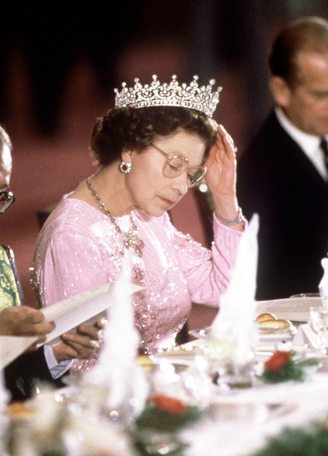 <p>                     Holding up your tiara while looking at a dinner menu might not be an experience we can all relate to but we love this picture of Queen Elizabeth II doing just that. At a banquet held in her honour in Peking, China in 1986 the Queen wore a beaded long-sleeve baby pink gown paired with her beloved Queen Mary's Girls of Great Britain and Ireland tiara.                   </p>
