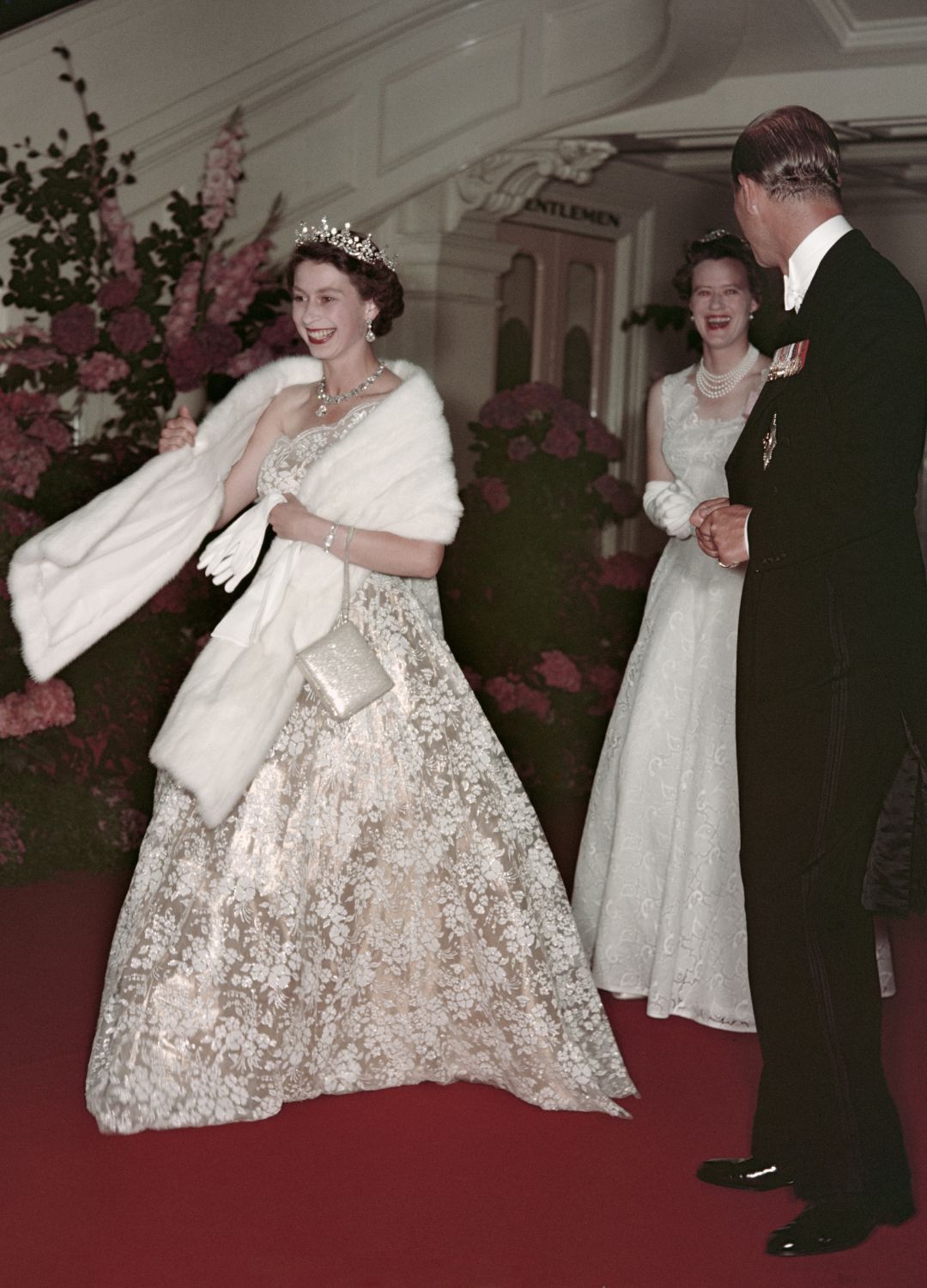<p>                     Over her 70-year reign, the late Queen travelled the world many times and often visited Australia on Commonwealth state visits. Seen here leaving a Banquet during her visit to the country in 1954, Queen Elizabeth II wears a breathtaking white lace gown with a matching fur shrug. The real star of the show is of course the Girls of Great Britain and Ireland tiara, one of her favourites.                   </p>