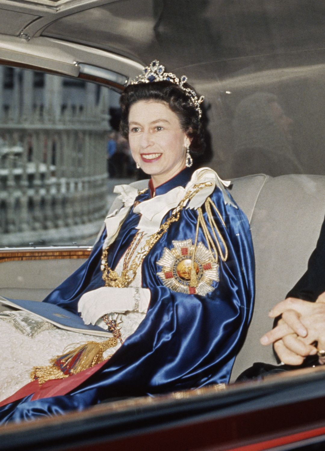<p>                     We simply love the Queen's colour-coordinated look here and her velvet blue cape perfectly matches the blue sapphires in her tiara. The diamond and sapphire headpiece was made from a necklace bought by the late Queen Elizabeth II in 1963, a necklace which previously belonged to Princess Louise of Belgium.                   </p>