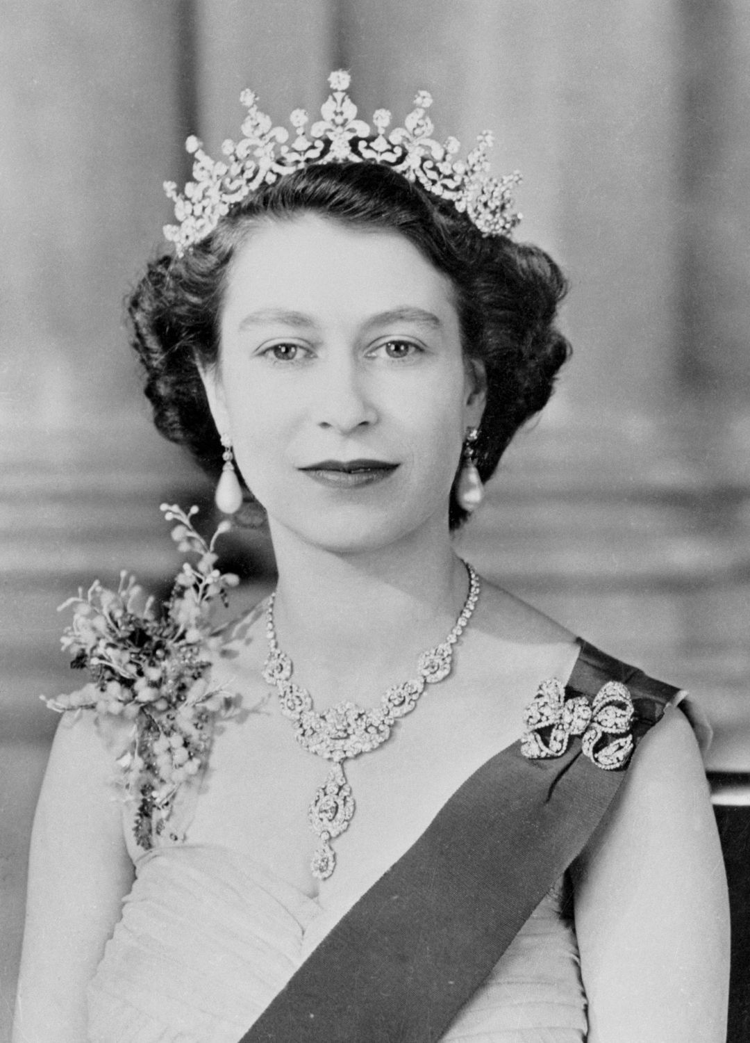 <p>                     Posing for a portrait alongside Prince Philip (not pictured here), Queen Elizabeth II wore her Blue Ribbon, Star of the Garter and the Girls of Great Britain and Ireland tiara that she received as a wedding present in 1947 from her grandmother. The portrait was taken shortly before the royal couple left for their six-month tour of the Commonwealth in 1954.                   </p>