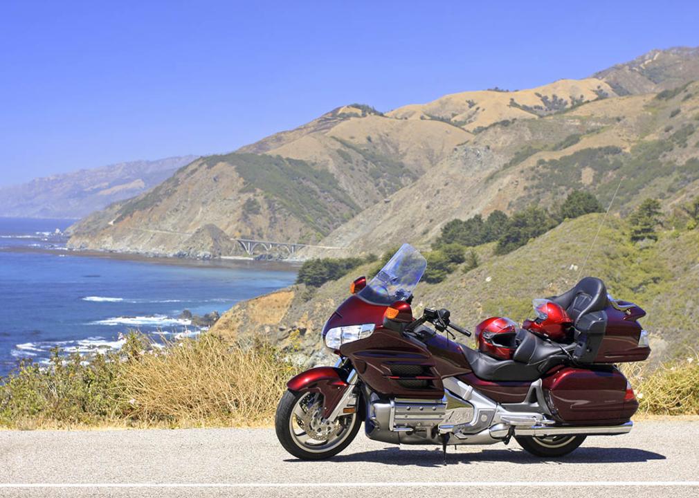 <p>This iconic highway stretches for over 600 miles along the California coast, from San Diego to Crescent City. The scenery is breathtaking, with stunning ocean views, rugged cliffs, and rolling hills. You'll also pass through some of the most charming towns in California, such as Carmel-by-the-Sea and Santa Barbara.</p>  <p><strong>A historical overview</strong></p>  <p>The <a href="https://www.visittheusa.com/trip/pacific-coast-highway-road-trip">Pacific Coast Highway</a>, fondly known as PCH or Highway One, is an iconic American road trip destination, winding its way along the breathtaking California coastline for over 600 miles. Its origins can be traced back to the early 1900s, when a series of local roads along the coast were gradually connected to form a continuous route. In 1929, the highway was officially named the Roosevelt Highway in honor of President Theodore Roosevelt, an avid outdoorsman and proponent of road development.</p>  <p><strong>A motorcyclist's paradise</strong></p>  <p>For motorcyclists seeking an unforgettable adventure, the Pacific Coast Highway offers a mesmerizing blend of scenic wonders and cultural gems. The highway hugs the coastline, offering panoramic views of the Pacific Ocean, rugged cliffs, and charming coastal towns. The route is dotted with viewpoints, parks, and historical landmarks, providing ample opportunities to stretch your legs, refuel, and immerse yourself in the rich heritage of the region.</p>  <p><strong>Popular stops and sights</strong></p>  <ol>  <li><a href="https://hearstcastle.org/">Hearst Castle</a>: Nestled amidst the rugged cliffs of San Simeon, this opulent estate built by newspaper magnate William Randolph Hearst offers a glimpse into the extravagant lifestyle of the Gilded Age.</li>  <li><a href="https://www.nepenthe.com/">Nepenthe</a>: Perched on a cliff overlooking the ocean, this iconic restaurant is renowned for its breathtaking views and its Ambrosia burger, a local legend.</li>  <li><a href="https://mcwayfalls.com/">McWay Falls</a>: A hidden gem tucked away in Julia Pfeiffer Burns State Park, this 80-foot waterfall cascades directly onto the beach, creating a picture-perfect scene.</li>  <li><a href="https://www.nps.gov/pore/index.htm">Point Reyes National Seashore</a>: This expansive coastal wilderness offers a diverse landscape of beaches, forests, and wildlife, providing opportunities for hiking, kayaking, and wildlife viewing.</li>  <li><a href="https://www.santamonicapier.org/">Santa Monica Pier</a>: This iconic pier, known for its Ferris wheel, amusement park rides, and arcade games, offers a lively and entertaining atmosphere.</li>  <li><a href="https://www.carmelcalifornia.com/">Carmel-by-the-Sea</a>: This charming town, nestled between the ocean and the Santa Lucia Mountains, boasts European-inspired architecture, art galleries, and boutique shops.</li>  <li><a href="https://www.visitcalifornia.com/places-to-visit/malibu/">Malibu</a>: Renowned for its stunning beaches, celebrity homes, and upscale boutiques, Malibu embodies the epitome of California's coastal allure.</li>  <li><a href="https://beaches.lacounty.gov/zuma-beach/">Zuma Beach</a>: This expansive stretch of sandy beach offers opportunities for surfing, sunbathing, and enjoying the laid-back beach vibe.</li>  <li><a href="https://www.parks.ca.gov/PointMugu/">Point Mugu State Park</a>: This park offers hiking trails, tide pools, and a visitor center with exhibits on local marine life.</li>  <li><a href="https://www.venturaharborvillage.com/">Ventura Harbor</a>: A picturesque harbor with a variety of restaurants, shops, and boat tours, providing a relaxing ambiance and stunning views of the coastline.</li> </ol>  <p><strong>Planning your motorcycle adventure</strong></p>  <p>To fully appreciate the Pacific Coast Highway's splendor, careful planning is essential. Consider the time of year, as fog can sometimes obscure coastal views. Pack appropriate clothing and gear for varying weather conditions. Familiarize yourself with the route and plan for stops along the way, including fuel, rest, and sightseeing. Most importantly, embrace the spirit of adventure and enjoy the journey!</p>