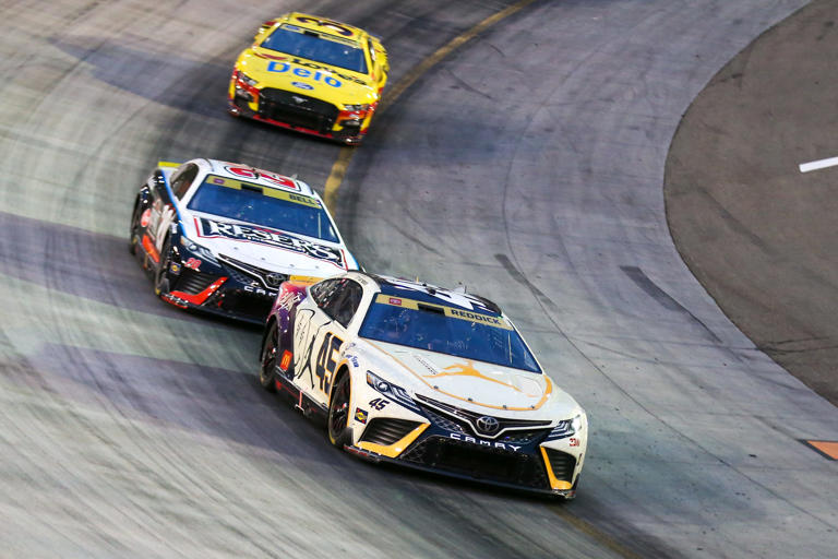 Sep 16, 2023; Bristol, Tennessee, USA; NASCAR Cup Series driver Tyler Reddick (45) leads driver Christopher Bell (20) during the Bass Pro Shops Night Race at Bristol Motor Speedway. Mandatory Credit: Randy Sartin-USA TODAY Sports