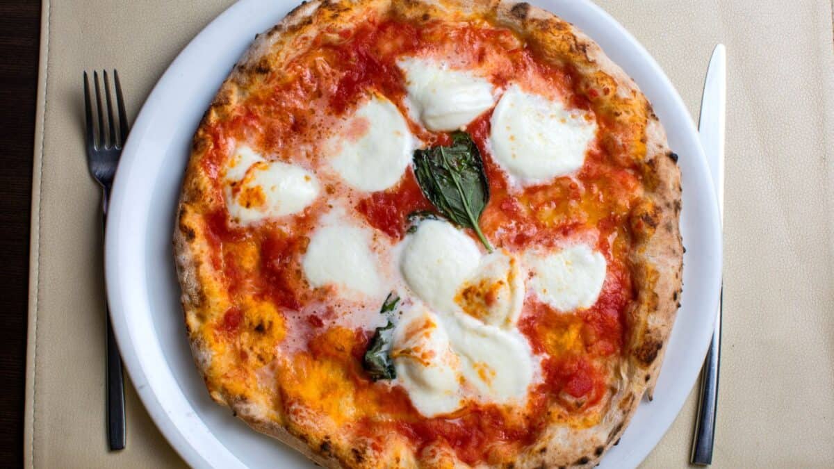 <p>Naples, the birthplace of pizza with 734 reviews, offers an authentic pizza experience unlike any other. </p><p><strong>Pizza Margherita</strong> is a must-try, and <strong>Pizzeria Da Michele</strong> is considered one of the best places to enjoy this simple yet delicious dish, featuring tomato, mozzarella, and basil.</p><p>The simplicity of Pizza Margherita, with its fresh ingredients and traditional baking methods, captures the essence of Neapolitan cuisine. Naples’ culinary landscape is a testament to the city’s rich history and vibrant culture, where food is celebrated as an art form. </p><p>The city’s narrow streets and bustling piazzas are filled with eateries that offer pizza and a variety of local dishes that are as soulful as the city itself.</p>