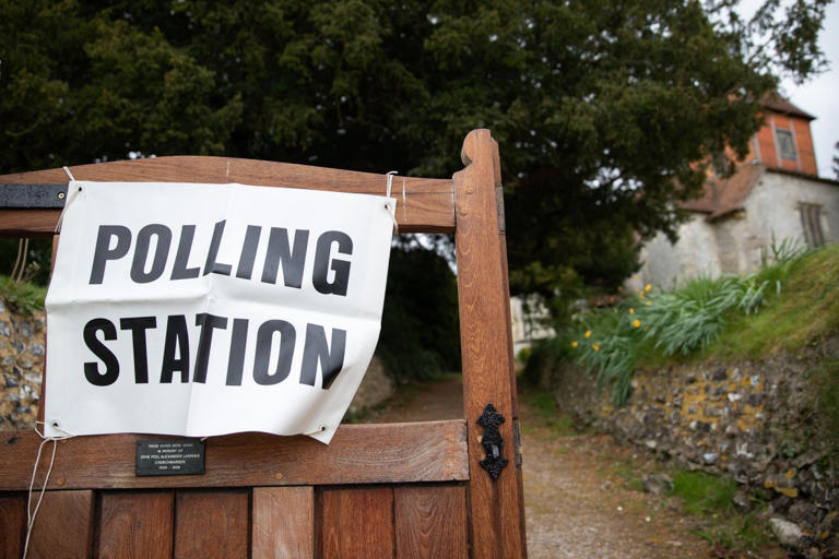 A polling station sign outside a church in Monk Sherborne in Hampshire