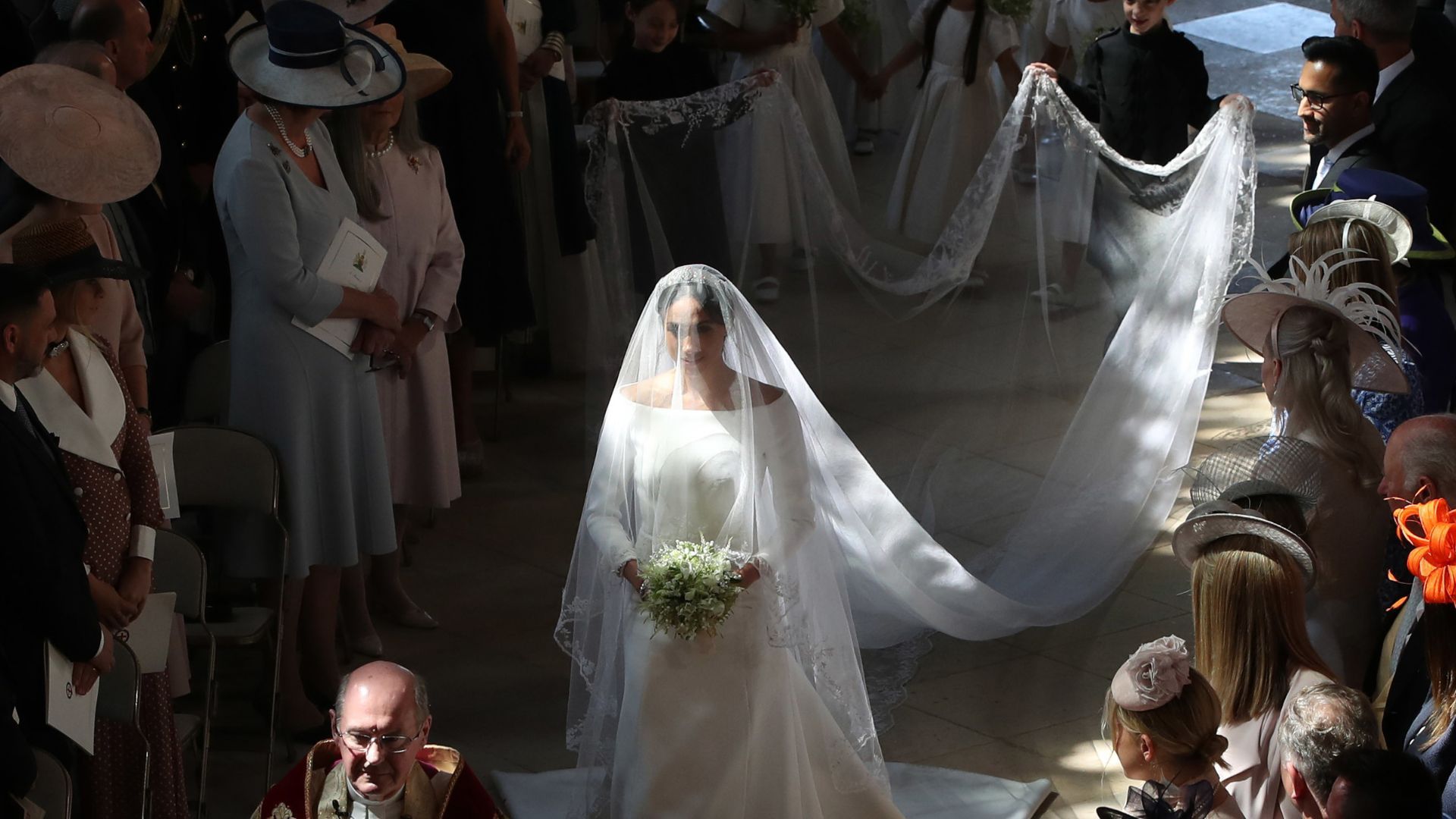 Meghan walked part of the aisle alone. 