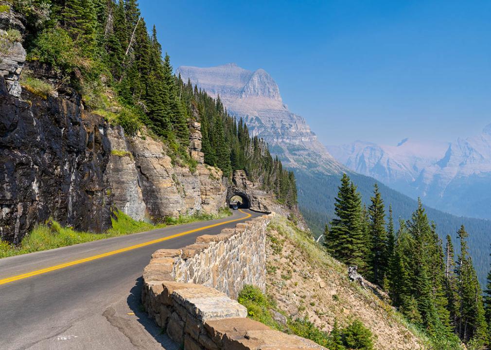 <p>This spectacular road winds its way through <a href="https://www.nps.gov/glac/index.htm">Glacier National Park</a>, offering stunning views of the Rocky Mountains. The road is only open for a few months each year, so be sure to plan your trip accordingly.</p>  <p>Nestled within the awe-inspiring embrace of Glacier National Park in Montana lies the<a href="https://www.nps.gov/glac/planyourvisit/goingtothesunroad.htm"> Going-to-the-Sun Road</a>, a 50-mile masterpiece of engineering that winds its way through the park's breathtaking landscapes. As you navigate this serpentine route, you'll be transported to a world of towering peaks, emerald lakes, and cascading waterfalls, all framed by the grandeur of the Rocky Mountains.</p>  <p><strong>A road borne of vision</strong></p>  <p>The Going-to-the-Sun Road's origins can be traced to the early 20th century, when visionary park superintendent Stephen Mather recognized the need for a road that would unveil Glacier National Park's hidden gems to the public. Construction began in 1921, and over the next two decades, workers painstakingly carved the road out of the mountainside, guided by a deep respect for the park's natural beauty.</p>  <p><strong>A season of splendor</strong></p>  <p>Due to its high elevation and susceptibility to snowpack, the Going-to-the-Sun Road is typically open only from late June to early October, making it a coveted destination for motorcyclists seeking an exhilarating ride amidst breathtaking scenery. As you traverse the road's hairpin turns and ascend to its highest point, Logan Pass, you'll be rewarded with panoramic vistas that will leave you breathless.</p>  <p><strong>Popular stops and sights for motorcyclists</strong></p>  <p>Along the Going-to-the-Sun Road, numerous stops and sights await motorcyclists, offering opportunities to immerse themselves in the park's natural wonders and rich history.</p>  <ol>  <li><a href="https://www.nps.gov/places/jackson-glacier-overlook.htm">Jackson Glacier Overlook</a>: Witness the grandeur of Jackson Glacier, a remnant of the Ice Age, from the Jackson Glacier Overlook. Take in the glacier's imposing presence as it descends into the valley below.</li>  <li><a href="https://www.visitmt.com/listings/general/lake/st-mary-lake">St. Mary Lake</a>: Stroll along the shores of St. Mary Lake, a serene body of water reflecting the towering peaks of the surrounding mountains. Rent a boat and explore the lake's tranquil waters or simply relax and soak in the tranquil atmosphere.</li>  <li><a href="https://discoveringmontana.com/waterfalls/mcdonald/">McDonald Falls</a>: Take a refreshing break at McDonald Falls, a cascading waterfall that plunges into a picturesque pool. Hike to the top of the falls or enjoy the scenic views from the viewing platform.</li>  <li><a href="https://www.visitmt.com/listings/general/visitor-information-center/logan-pass-visitor-center">Logan Pass</a>: At the summit of Going-to-the-Sun Road, Logan Pass offers panoramic views of the Continental Divide and the surrounding mountain peaks. Hike to the summit of Clements Mountain for even more breathtaking vistas.</li>  <li><a href="https://www.hikinginglacier.com/sun-point-nature-trail.htm">Sun Point</a>: Ascend to Sun Point, a scenic overlook that provides stunning views of the Garden Wall, a sheer rock face that rises dramatically from the valley below. Take a moment to appreciate the geological forces that shaped this awe-inspiring landscape.</li> </ol>  <p>The Going-to-the-Sun Road, with its winding paths, breathtaking vistas, and rich history, is a must-do for any motorcyclist seeking an unforgettable adventure. As you navigate this iconic route, be mindful of the park's wildlife, respect its natural beauty, and create memories that will last a lifetime.</p>
