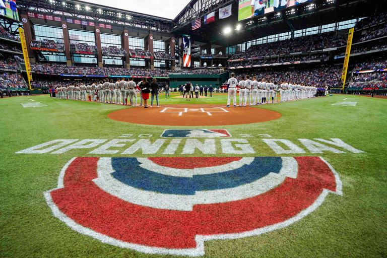 Texas Rangers and Philadelphia Phillies players line up for the national anthem before the Rangers season opener against the Philadelphia Phillies at Globe Life Field on Thursday, March 30, 2023.