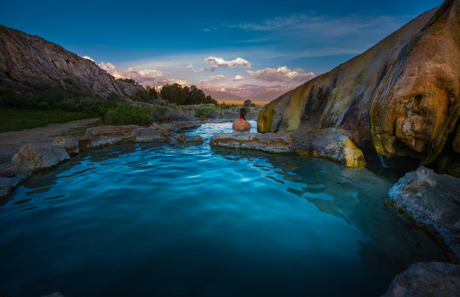 <p>These shallow thermal pools offer incredible sunsets views over California’s Eastern Sierra. Lined with silky soft, mineral-rich clay, the piping hot water from the source is cooled to a glorious 102°F as it flows over the rocks to form these pools. You’ll find Travertine Hot Springs a five-minute drive from Bridgeport and, be warned, clothing is optional. </p>