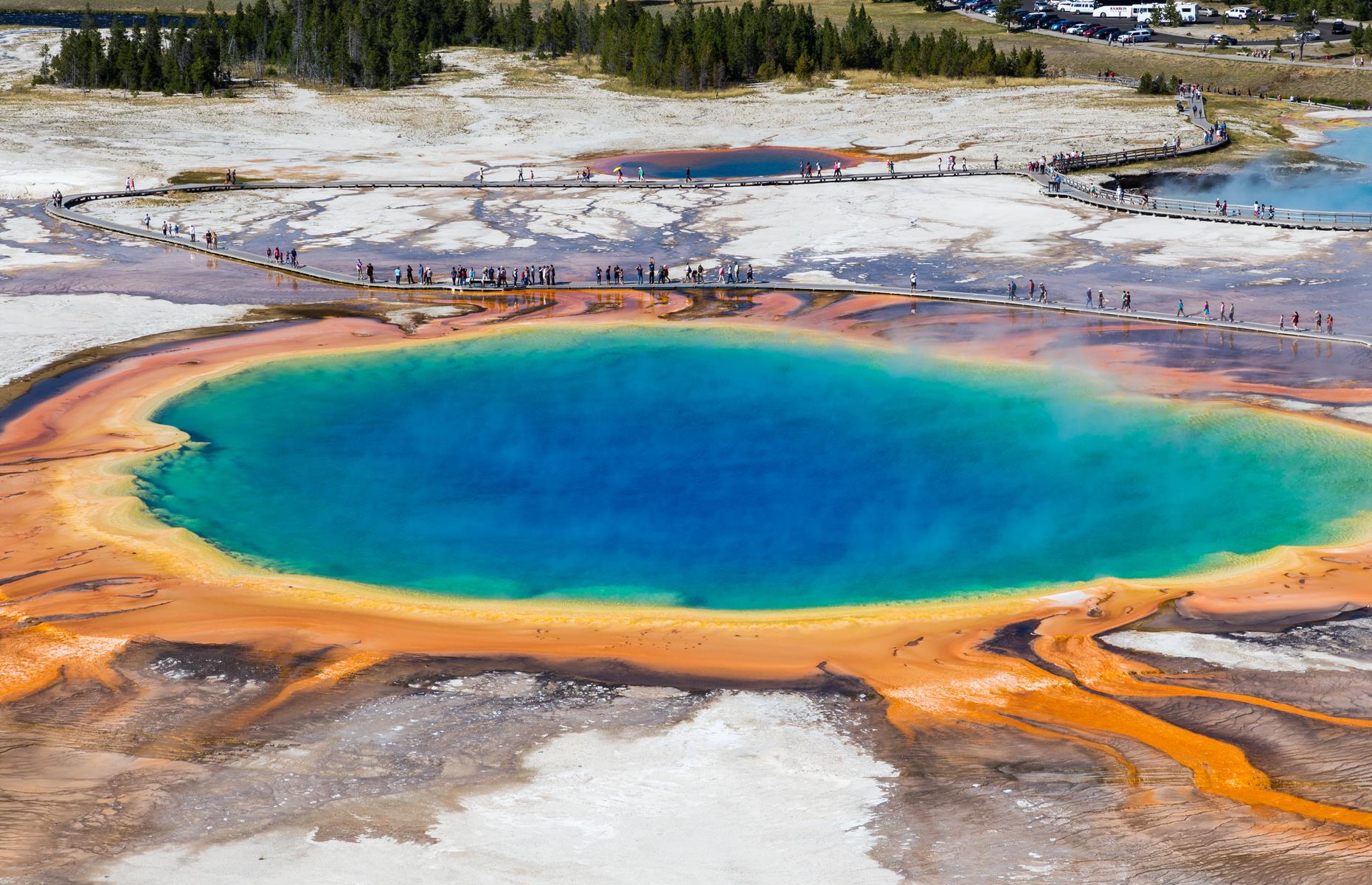 <p>With its vivid blue center, surrounded by bands of yellow, rusty orange and green, Grand Prismatic Spring in Yellowstone National Park looks almost otherworldly. The depths of this lake, filled with bubbling thermal waters, plunge as deep as 160 feet (49m). The psychedelic colors are caused by bacteria in the water. You can't bathe here, but head north to Mammoth to enjoy a soak in Boiling River. </p>