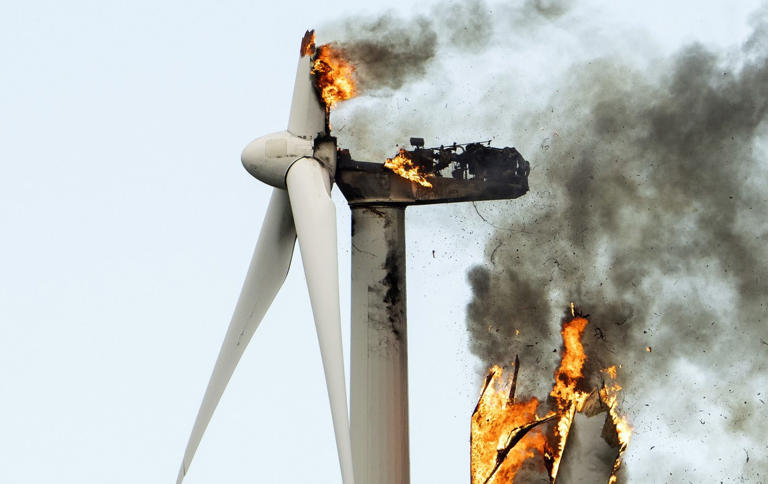 A wind turbine falls apart after catching fire. US county governments are increasingly refusing to host renewable energy industries - EPA-EFE/Shutterstock