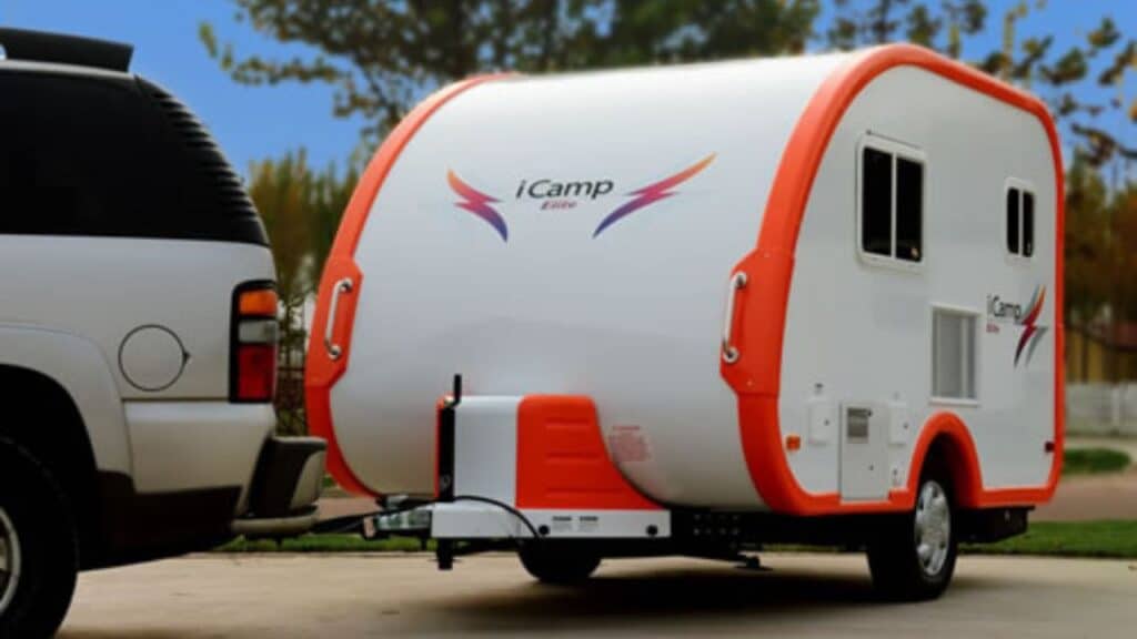 <p>The iCamp Elite camper is a super lightweight (1,337lbs) and compact trailer. It’s the perfect vehicle to quickly prep and hitch to your car for a weekend or holiday adventure. The <a href="https://www.thewaywardhome.com/teardrop-trailers/">teardrop</a> shape allows you to store bikes on the front, above the hitch.</p><p>There’s only one floorplan, but you can choose between an orange or blue package. Inside, there are a kitchen with a sink and stove, a wet bath, and a dinette that turns into a double bed. Every space is small but workable. It’s the price to pay for having a tiny trailer with all the comforts.</p><p>Even though it’s extra light, the iCamp Elite is well built. The steel frame is overlayed with a laminated structure foam body and finished with a gel coat of high-gloss fiberglass exterior skin. No wonder it’s so shiny.</p>