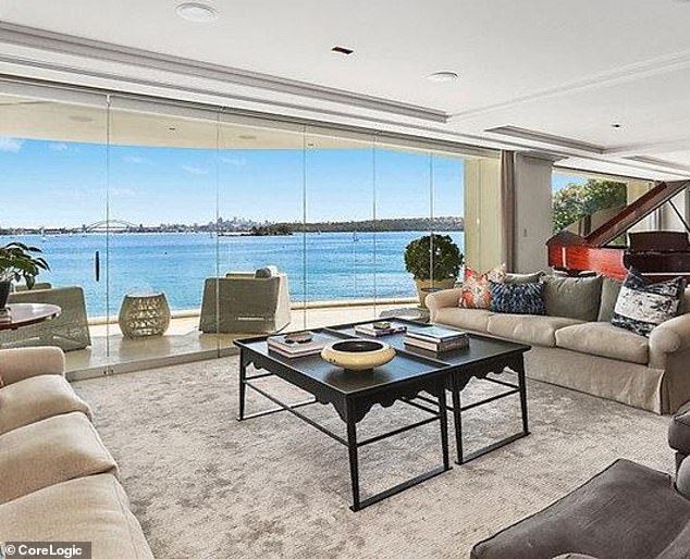 neighbours at war in one of sydney's richest suburbs: mansion owner is dealt another bitter blow after complaining about six palm trees 'ruining her $27million harbour views'