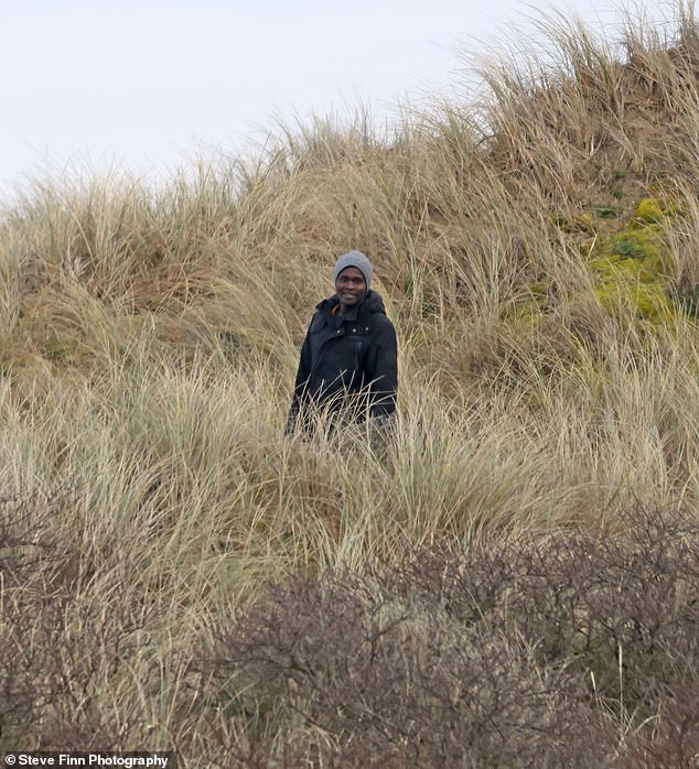 huge group of migrants seen walking from the beach in calais following 'abortive channel crossing after boat failed to inflate'