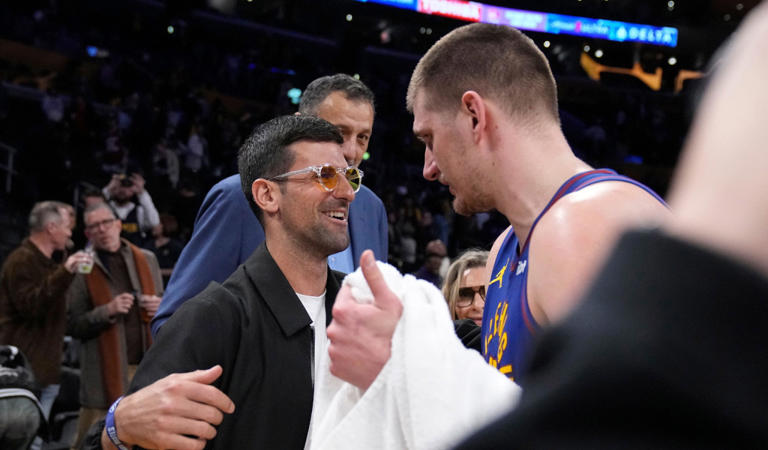 Tennis player Novak Djokovic, left, greets Denver Nuggets center Nikola Jokic after the Nuggets defeated the Los Angeles Lakers 124-114 in an NBA basketball game Saturday, March 2, 2024, in Los Angeles. (AP Photo/Mark J. Terrill)