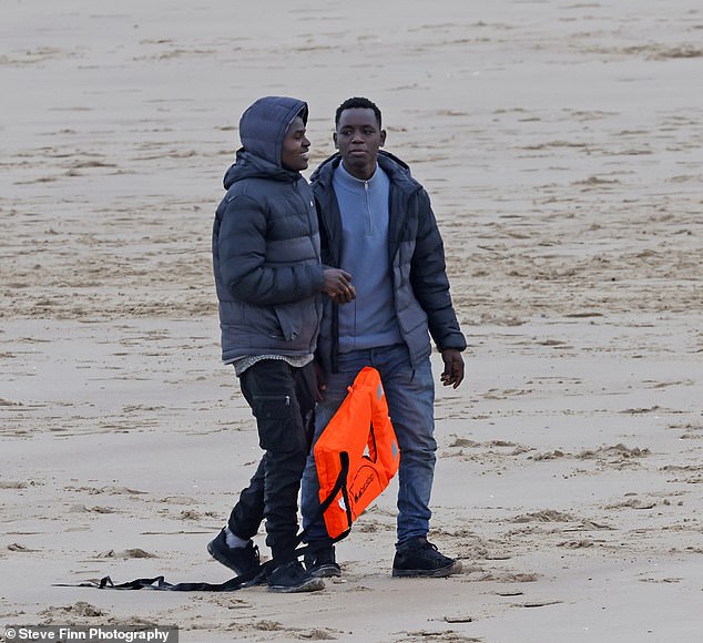 huge group of migrants seen walking from the beach in calais following 'abortive channel crossing after boat failed to inflate'
