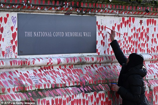 a minute's silence for britain's covid victims: bereaved families gather by memorial wall on first national day of reflection four years after virus outbreak