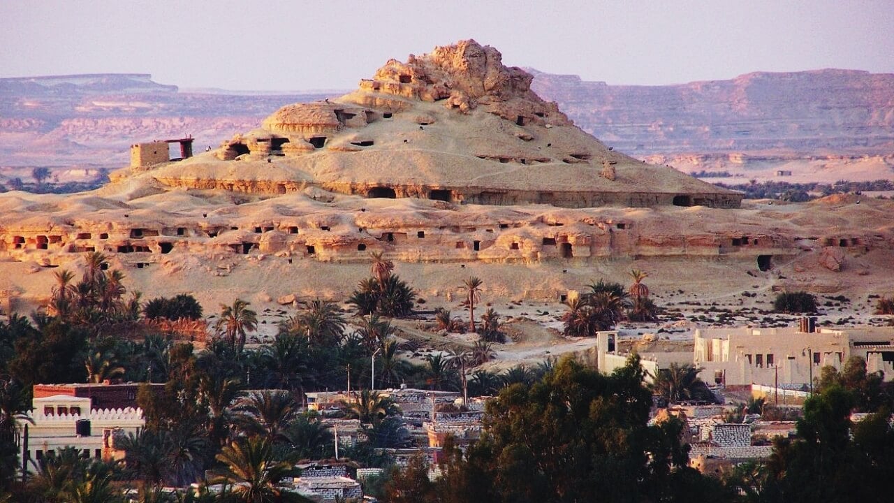 <p>Situated in the Siwa oasis, these mountains got their name due to the amount of tombs that can be found there. The most famous one is Si-Amun’s. The exteriors might be deceiving, but the inside of the tombs are usually painted with extreme detail, especially on grounds like Gebel Al-Mawta. </p>