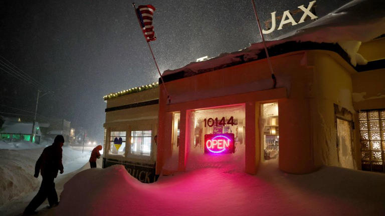 Patrons enter Jax At The Tracks diner past snow drifts in downtown Truckee, California, on March 3, 2024. - Jane Tyska/Bay Area News Group via AP