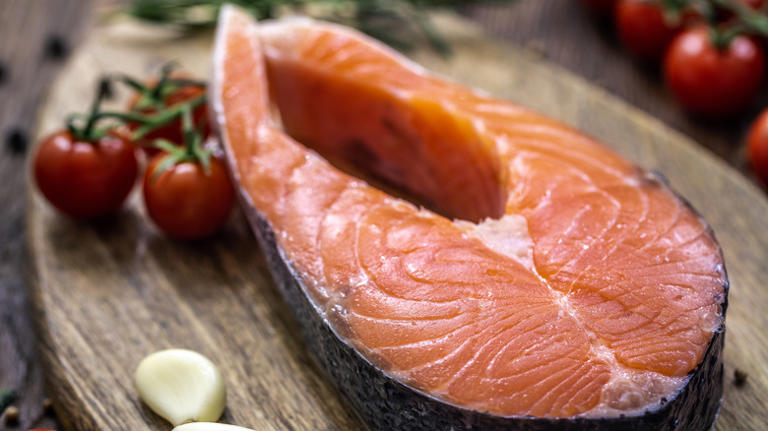 Why You Should Roll Salmon Steaks Before Grilling Them