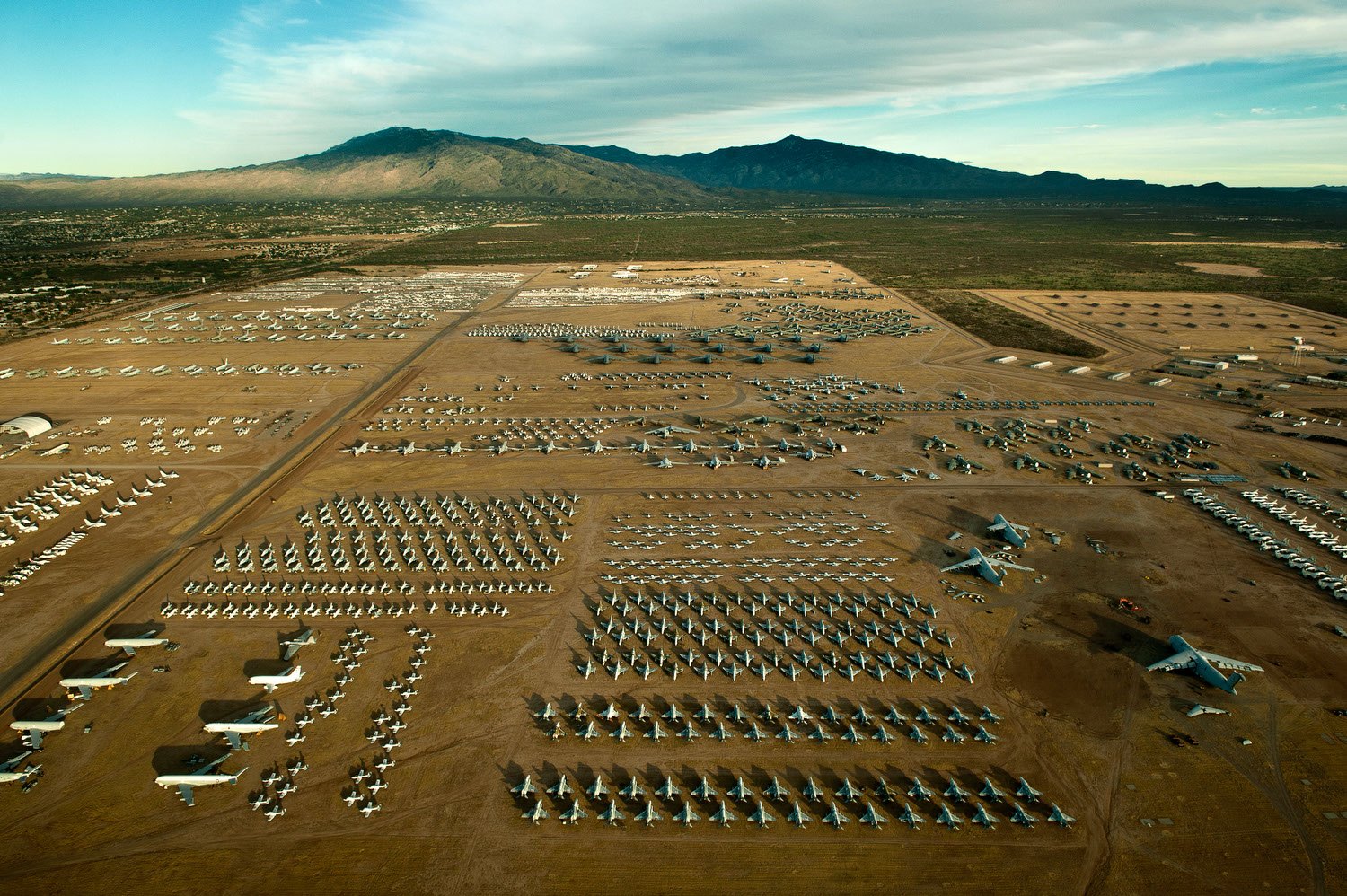 The Aircraft Boneyard in Tucson, Arizona, spanning 2,600 acres, serves as the final resting place for thousands of retired military and civilian aircraft. Its location in the arid desert ensures optimal conditions for long-term storage, minimizing corrosion and deterioration.