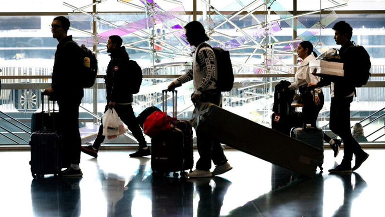 People walk through the Salt Lake City International Airport on Wednesday, Nov. 21, 2023.