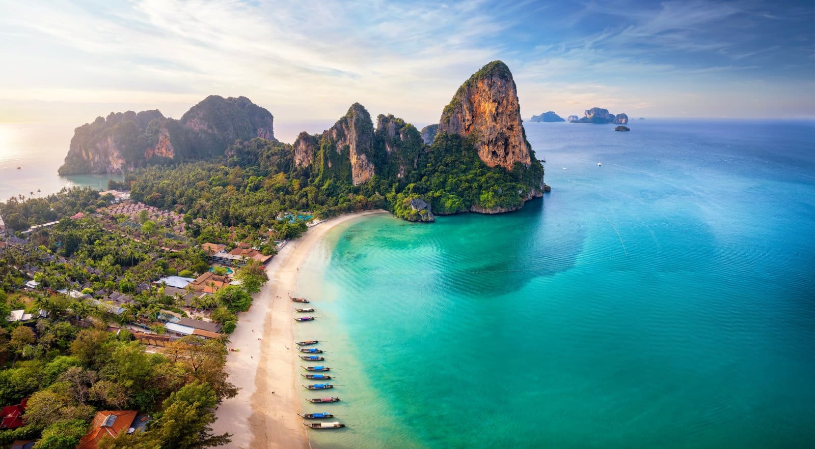 <p><span>In Krabi Province, you’ll find yourself amidst some of Thailand’s most picturesque landscapes, marked by dramatic limestone cliffs, pristine beaches, and clear blue waters. The province is renowned for destinations like Railay Beach, which is accessible only by boat. It offers world-class rock climbing and stunning beachscapes.</span></p> <p><span>The Phi Phi Islands, with their iconic beaches and vibrant marine life, are perfect for day trips, offering opportunities for snorkeling and diving. For a more tranquil experience, the lesser-known Koh Lanta provides a laid-back atmosphere with its long, sandy beaches. </span><span>Krabi’s natural beauty extends beyond its coastline, with inland attractions like the Emerald Pool and the Tiger Cave Temple, each offering unique experiences.</span></p> <p><span>Whether you’re seeking adventure on the cliffs of Railay or tranquility on the beaches of Koh Lanta, Krabi presents a diverse array of natural wonders waiting to be explored.</span></p> <p><b>Insider’s Tip: </b><span>Explore the mangroves and limestone caves by kayak for a unique perspective.</span></p> <p><b>How To Get There: </b><span>Krabi has an airport, and it’s also accessible by bus and boat from other parts of Thailand.</span></p> <p><b>Best Time To Travel: </b><span>Visit from November to March for the best beach weather.</span></p>