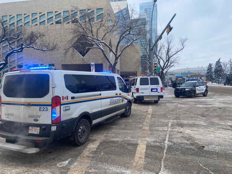 Emergency crews are seen at Edmonton City Hall on Tuesday, Jan. 23, 2024 after people reported hearing loud bangs. Police said they were investigating a weapons complaint.