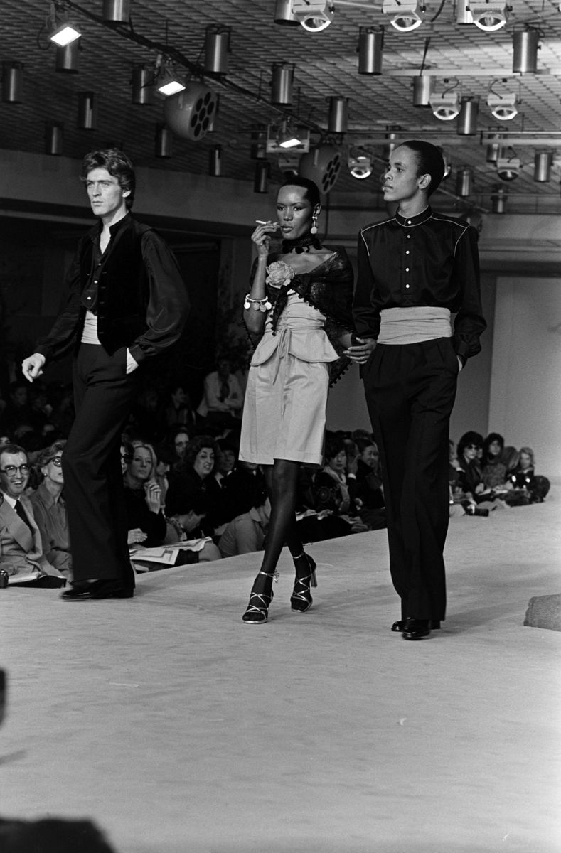 <p>Grace Jones walking the runway with male models for the Yves Saint Laurent Spring Menswear Collection runway show in 1976.</p>