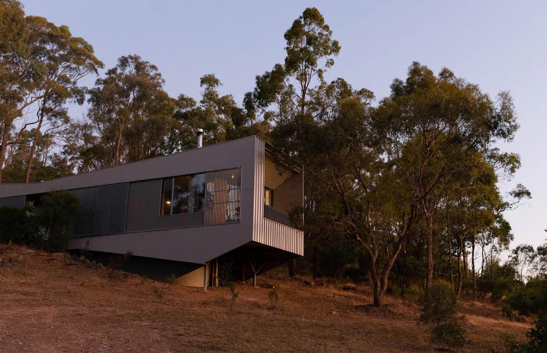 <p>Designed by Insite, the unique property is both eco-friendly and innovative. Imbued with Japanese influences, it features a bold, cantilevered design that allows it to "sit off the land yet be immersed within it", the <a href="https://insitedesign.com.au/base-camp">architects explain</a>. Crafted with bushfire and ESD (Ecologically Sustainable Development) principles in mind, it boasts solar hot water, a rainwater tank and super insulation.</p>