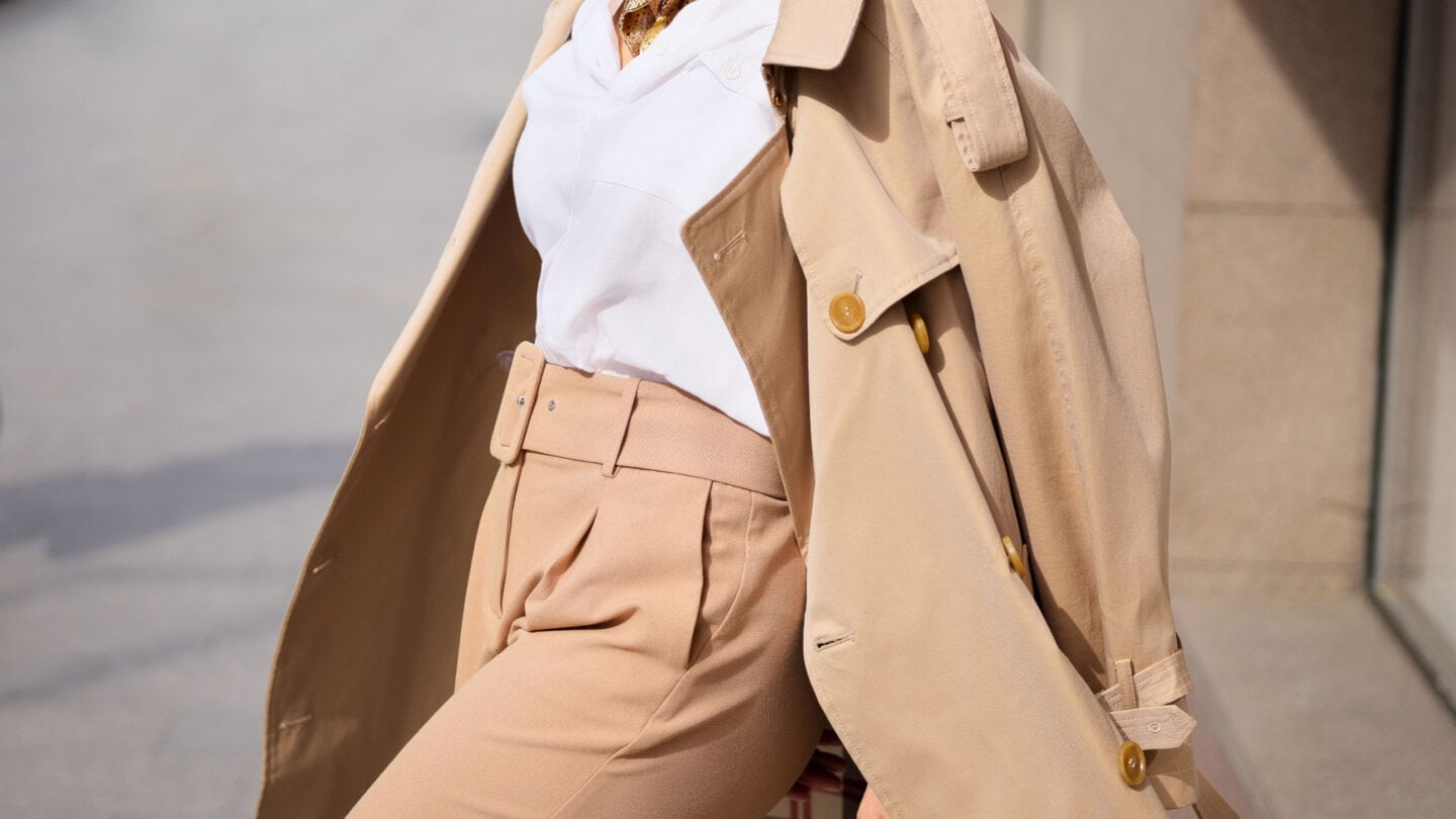 <p class="has-text-align-center"><strong>Photo Credit:</strong> Shutterstock</p> <p class="has-text-align-left">This sophisticated combination exudes a classic yet contemporary aesthetic, perfect for making a polished statement in the workplace. The lightweight trench coat adds a touch of refinement to the ensemble, while the high-waisted trousers create a sleek and tailored silhouette. Whether you’re navigating through a busy workday or attending a networking event, this outfit exudes confidence and professionalism. Paired with a crisp blouse and sophisticated heels, this versatile ensemble transitions from day to evening. </p>