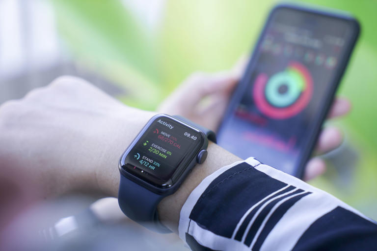 Woman using smart watch and smart phone, Apple watch