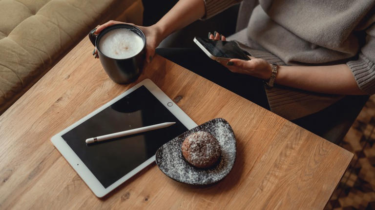 Woman writing note on an iPad