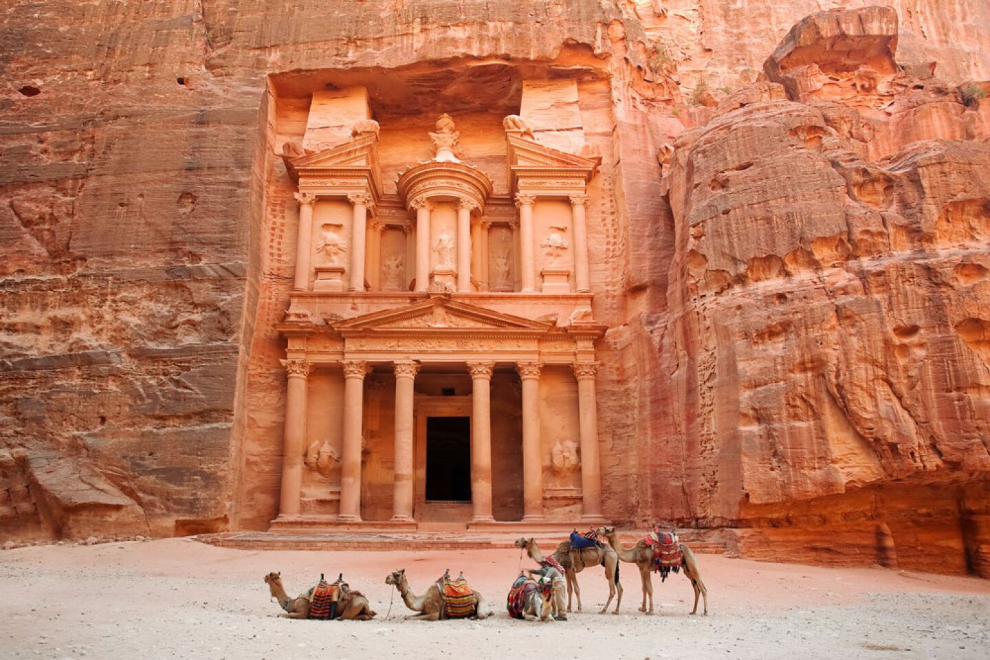 <h2>6. Petra</h2> <p><i>Wadi Musa, Jordan</i><br> During its zenith, <a class="Link" href="https://whc.unesco.org/en/list/326" rel="noopener">Petra</a>, Jordan’s most famous archaeological site, was a bustling commerce center where citizens traded Arabian incense, Chinese silks, and Indian spices. Nabateans built the ancient city in the country’s southwestern desert in 400 B.C.E., but it was unknown to the Western world until the 1800s. Accessed via a narrow canyon and with towering temples and tombs carved into pink sandstone cliffs (earning it the name “The Red Rose City”), it feels otherworldly. Perhaps that’s why Petra’s treasury stood in for the temple housing the Holy Grail in <i>Indiana Jones and the Last Crusade</i>.</p> <p> <b>How to visit</b><br>This UNESCO World Heritage site is about 150 miles south of Jordan’s capital, Amman. Most visitors access Petra Archaeological Park through Wadi Musa, a nearby town with a handful of luxurious hotel offerings for travelers who make the trip to the rock-wall crypts. One-day tickets for visitors who spend at least a night in Jordan cost approximately $70 for adults; entry for children 12 and under is free.</p>