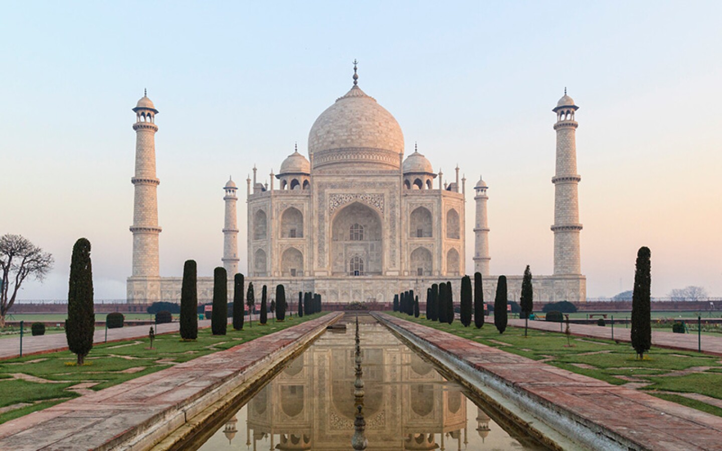 <h2>10. Taj Mahal</h2> <p><i>Agra, India</i></p> <p> The perfectly symmetrical <a class="Link" href="https://whc.unesco.org/en/list/252" rel="noopener">Taj Mahal</a> features a 240-foot-tall central dome and an exterior with inlaid semiprecious stones. Widely considered the most beautiful existing example of Mughal architecture, the white marble mausoleum was erected between 1631 and 1648 after Mughal Emperor Shah Jahan ordered its construction to honor his late wife. (He tapped approximately 20,000 of the best craftsmen from Central Asia to complete the project.) Jahan intended to build a second mausoleum for himself, but the building never came to fruition. After he passed away in 1666, the emperor was buried next to his wife. Visitors to this World Heritage site can explore the grounds’ vast garden featuring long reflecting pools of water and a red sandstone gate. </p> <h3>How to visit</h3> <p> Most people visit the Taj Mahal on a day trip from Delhi. There are many high-speed trains to Agra from Delhi, Varanasi, and cities across northern India’s Rajasthan state. Tickets cost approximately $13 for adults; entry for children 15 and younger is free.</p>