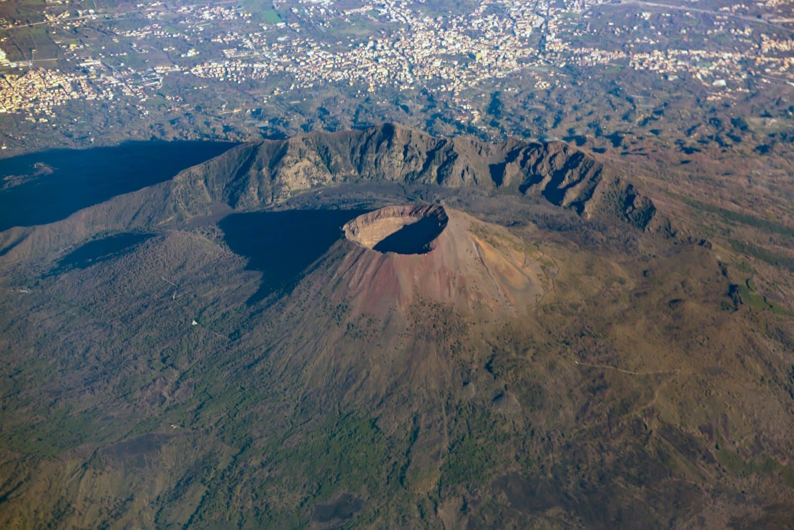 <p><span>The infamous Mount Vesuvius, a symbol of nature’s unpredictable power, offers a unique historical and geological exploration. Overlooking the bustling city of Naples, this active volcano is best known for its catastrophic eruption in AD 79, which buried the ancient cities of Pompeii and Herculaneum.</span></p> <p><span>Hiking to the summit of Vesuvius provides a physical challenge and an educational journey into the history of one of the world’s most famous volcanic eruptions. The panoramic views from the crater rim are a stunning contrast between the serene beauty of the Bay of Naples and the latent power of the volcano.</span></p> <p><b>Insider’s Tip: </b><span>Combine your visit with a tour of the Pompeii ruins for a complete historical experience.</span></p> <p><b>When To Travel: </b><span>Spring (April to June) or fall (September to October) to avoid extreme heat.</span></p> <p><b>How To Get There: </b><span>Fly into Naples International Airport and take a short drive or a guided tour to Mount Vesuvius.</span></p>