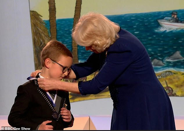 The Queen also presented Evan from London with a gold medal for his story Message in a Bottle in the 5-7 age category