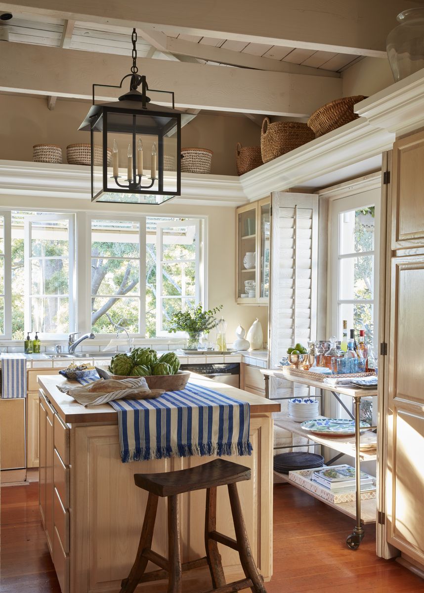 <p>In the small kitchen of <a href="https://www.veranda.com/decorating-ideas/house-tours/a38897261/suzanne-tucker-montecito-cottage-tour/">their Montecito cottage</a>, design luminaries Suzanne Tucker and Timothy Marks lean on clever storage solutions like this three-shelf wheeled cart (Suzanne Kasler for <a href="http://www.hickorychair.com/">Hickory Chair</a>) that serves as beverage trolley, extra prep surface, and servingware storage. Large baskets tuck under the rafters.</p>