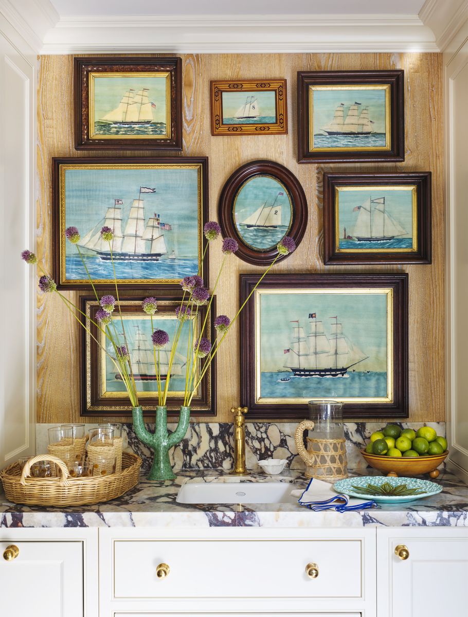 <p>At <a href="https://www.veranda.com/decorating-ideas/house-tours/a43474733/summer-thornton-lake-michigan-inn-tour/">this Michigan lakeside retreat</a>, designer Summer Thornton infused this tiny prep sink space with big nautical energy thanks to a collection nostalgic boat paintings by <a href="https://go.redirectingat.com?id=74968X1553576&url=https%3A%2F%2Fmarymaguireart.myshopify.com%2F&sref=https%3A%2F%2Fwww.veranda.com%2Fdecorating-ideas%2Fg34899885%2Fsmall-kitchens%2F">artist Mary Maguire</a> and shipshape brass hardware.</p>